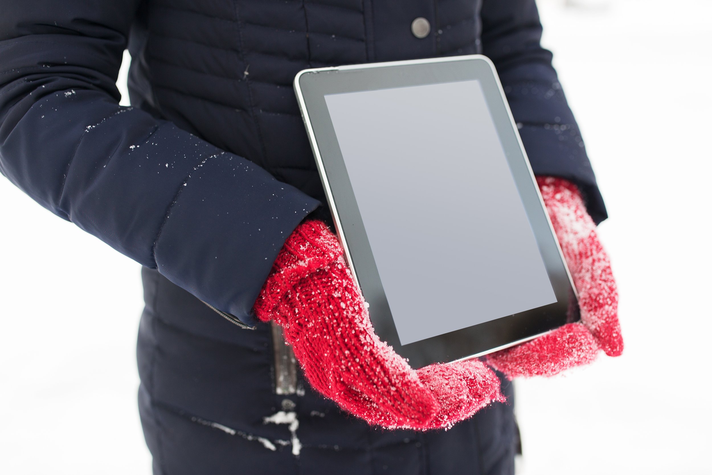 woman with tablet pc computer in winter outdoors