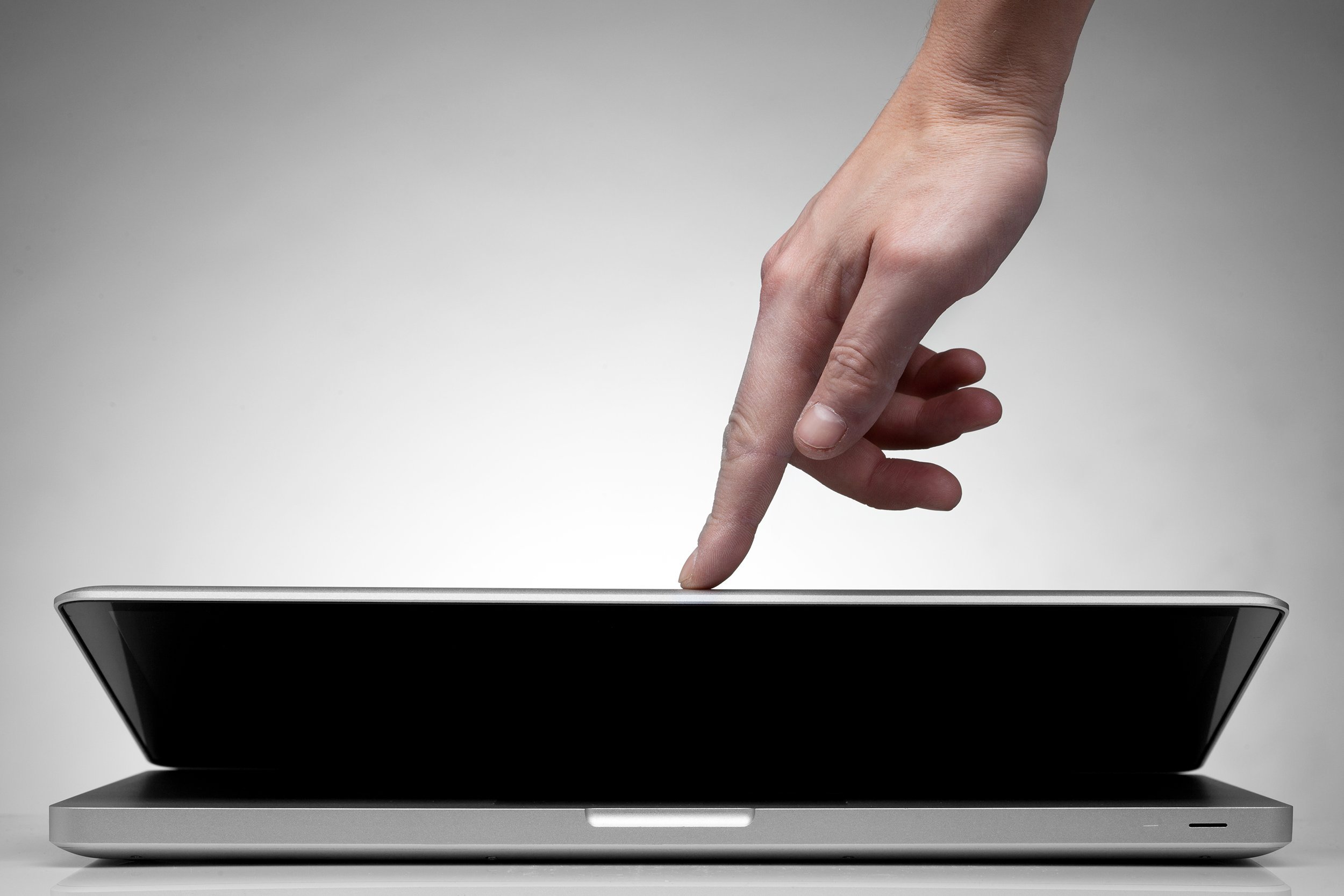 hand closing laptop
