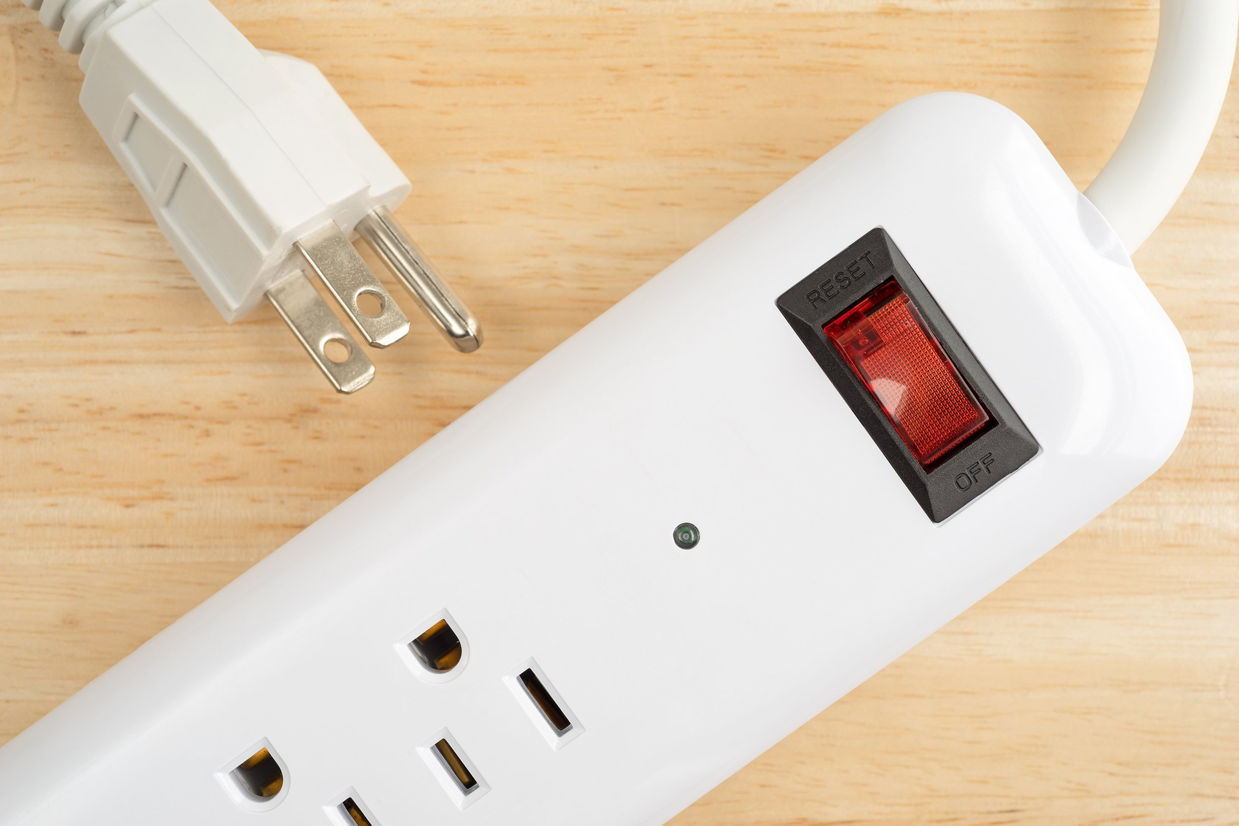household surge protector on a wood table top