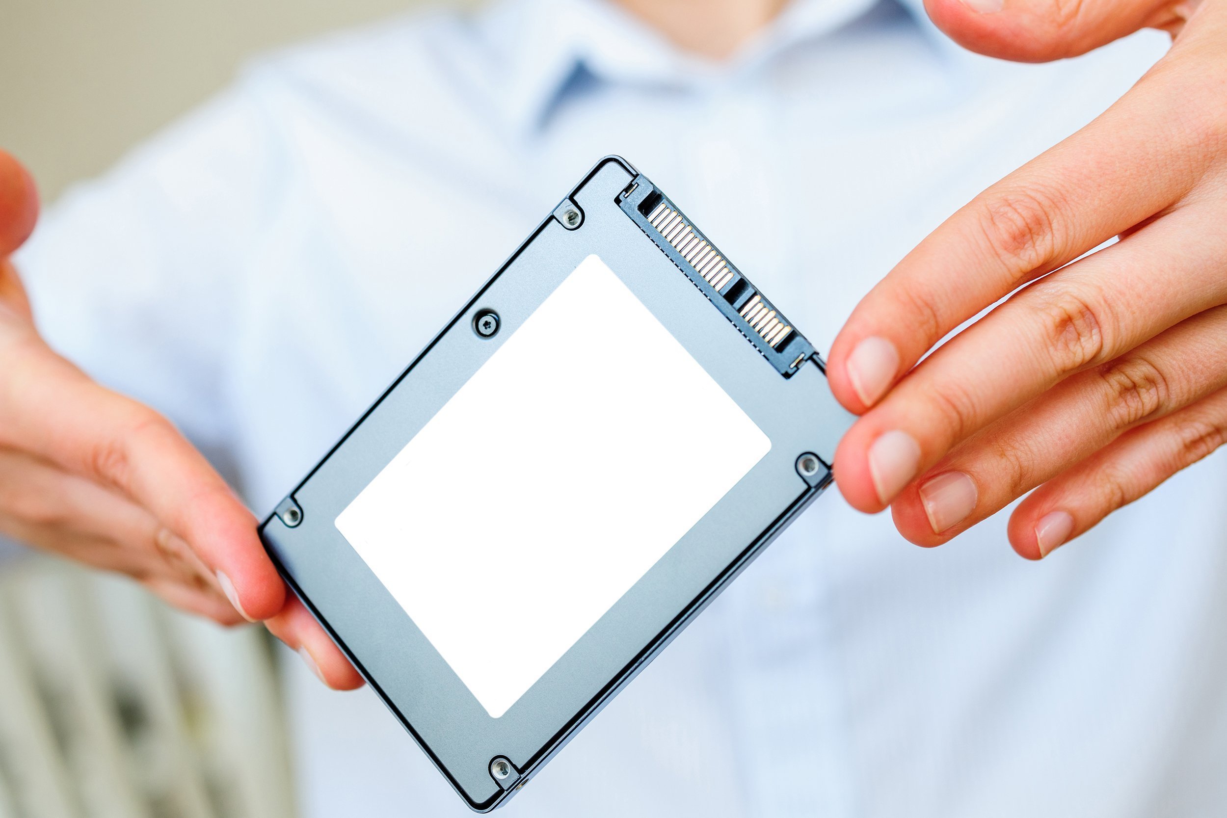 hands holding fast flash SSD