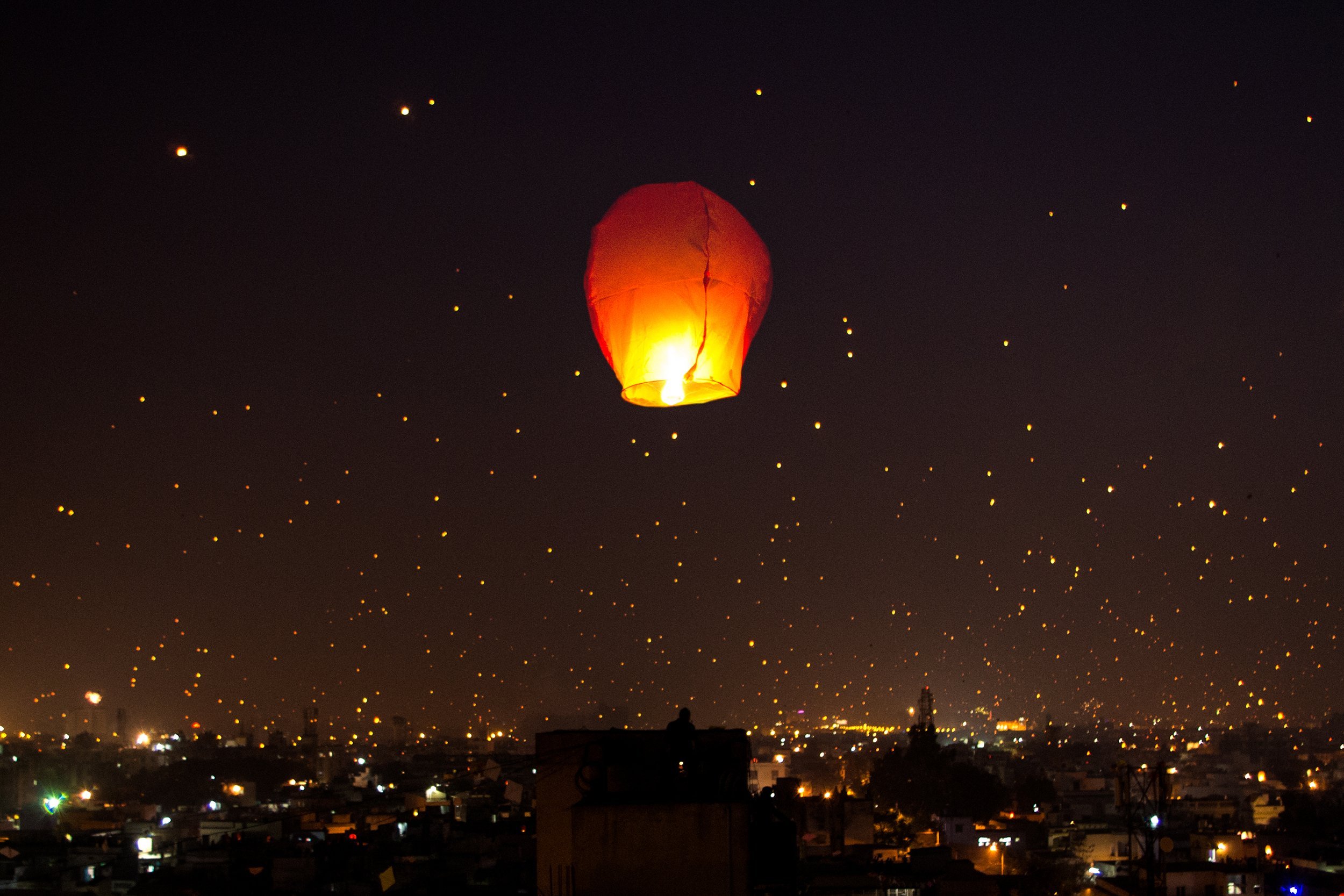 a night lit up on Makar Sankranti Uttarayana Festival with kites and lights