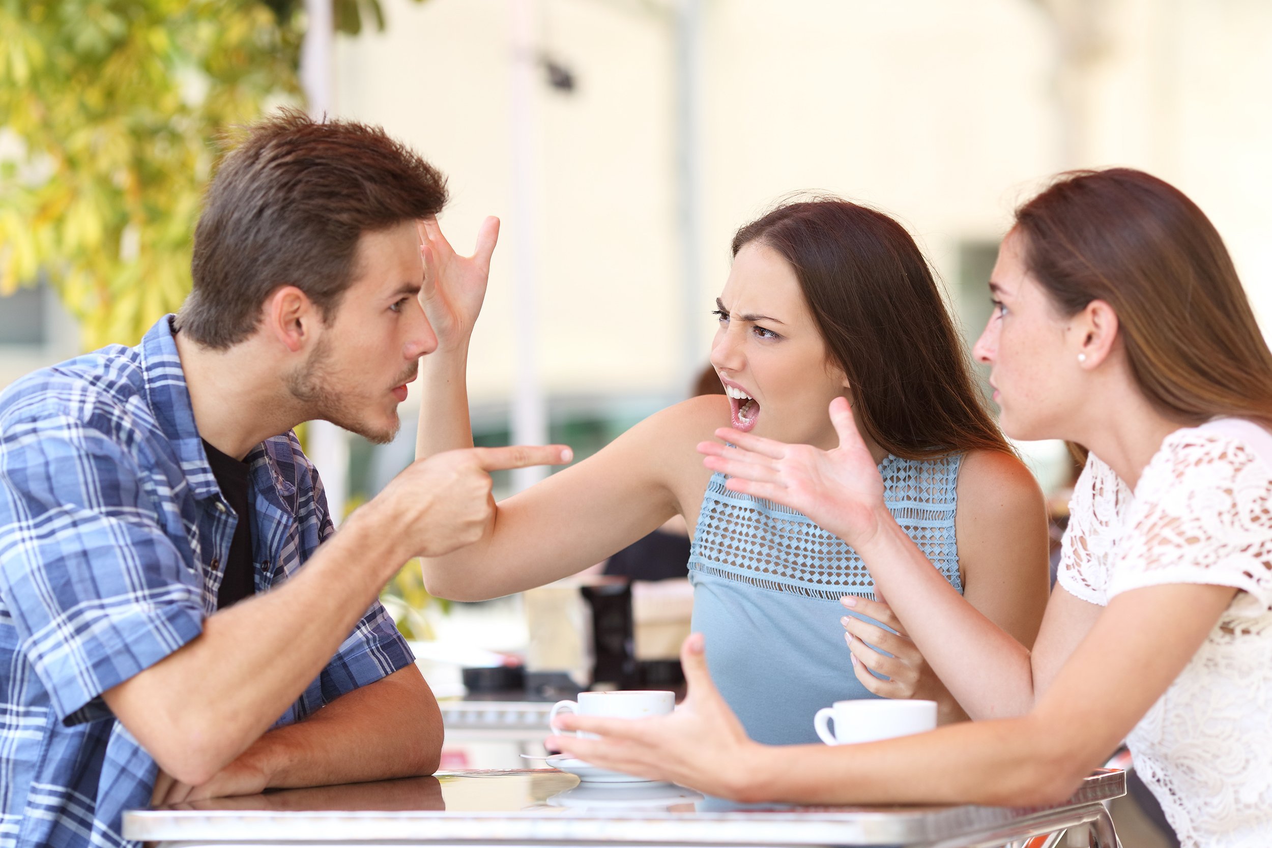 discussion of three angry friends arguing in a coffee shop