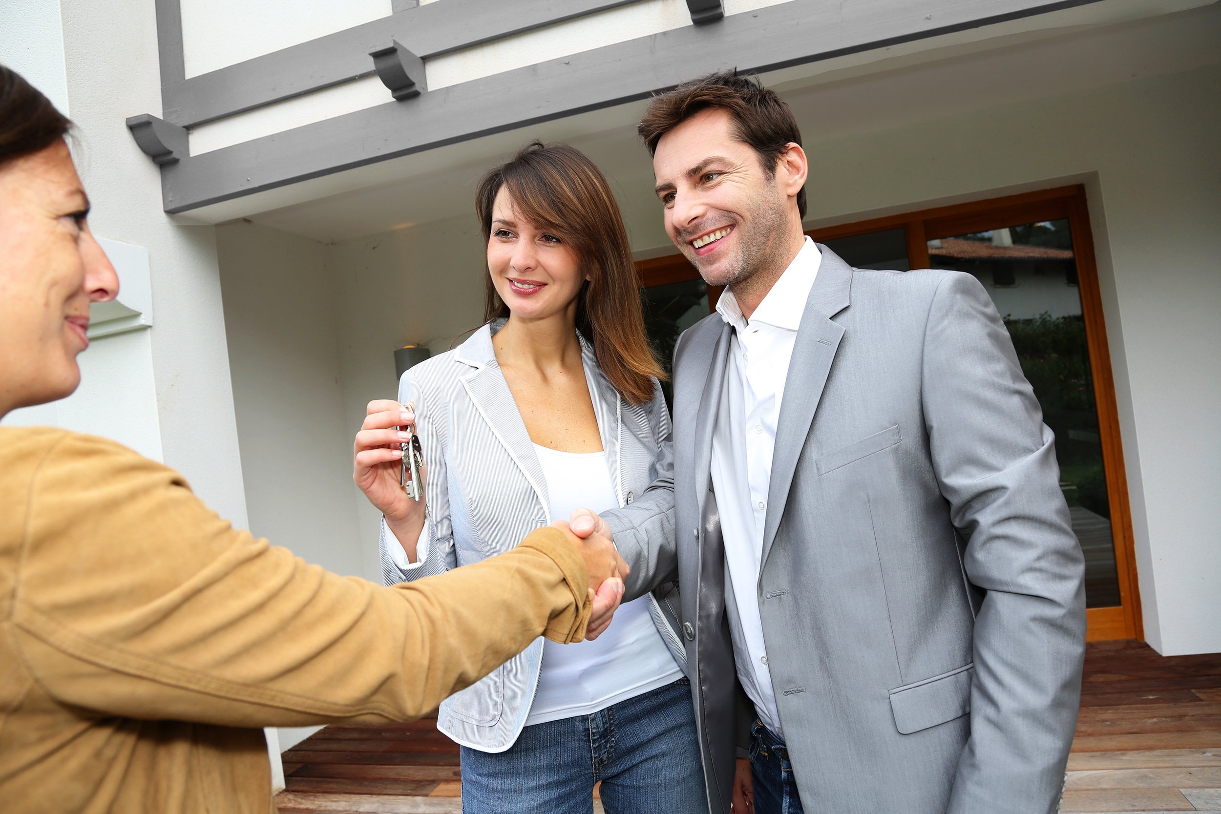 new property owners shaking hands to sales agent