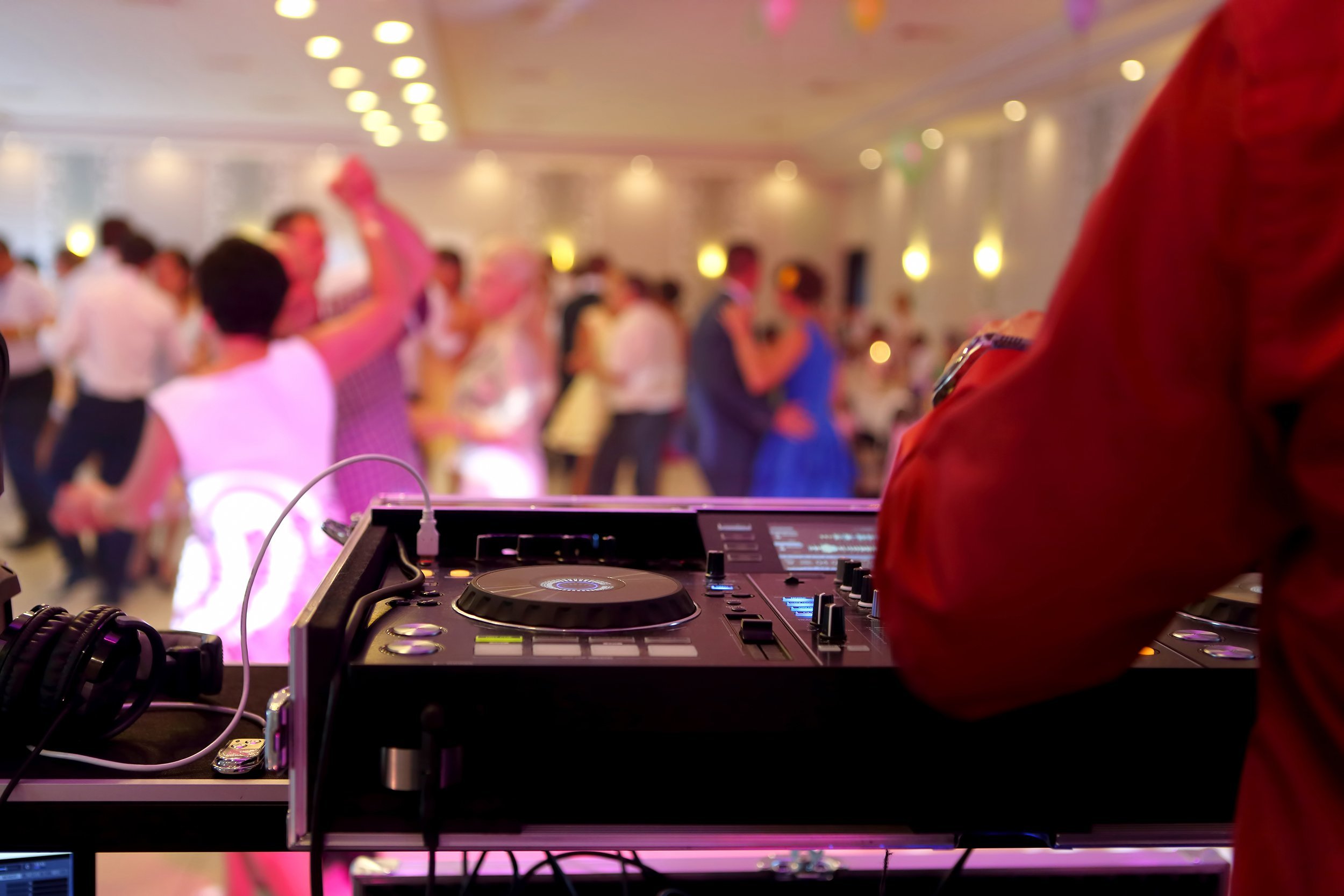 dancing couples during wedding celebration with DJ playing