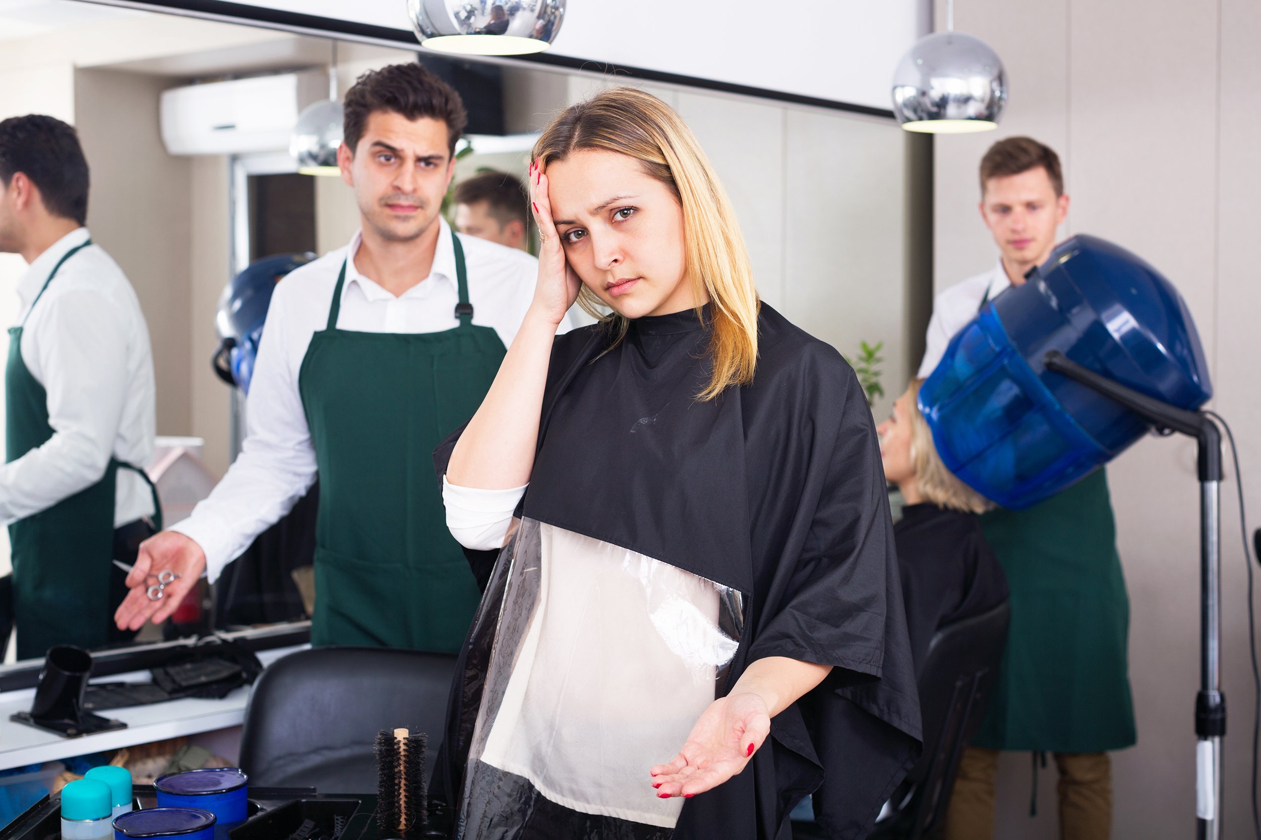 angry woman blaming hairdresser in bad haircut