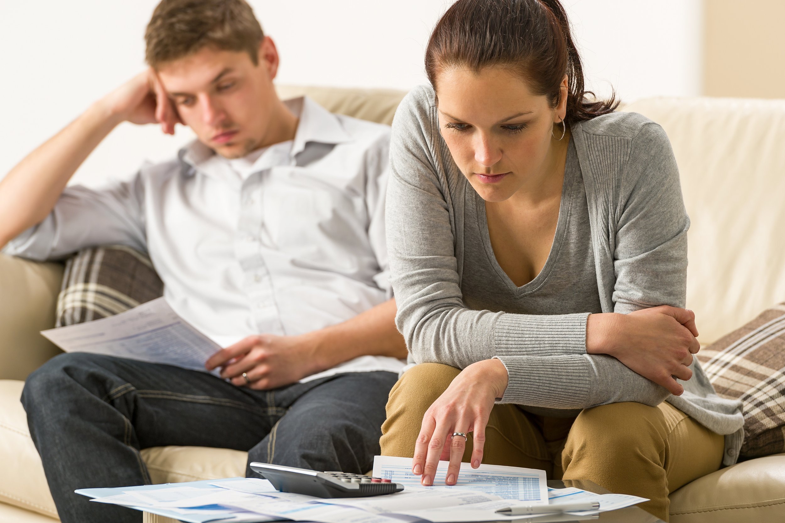 annoyed couple calculating their finances