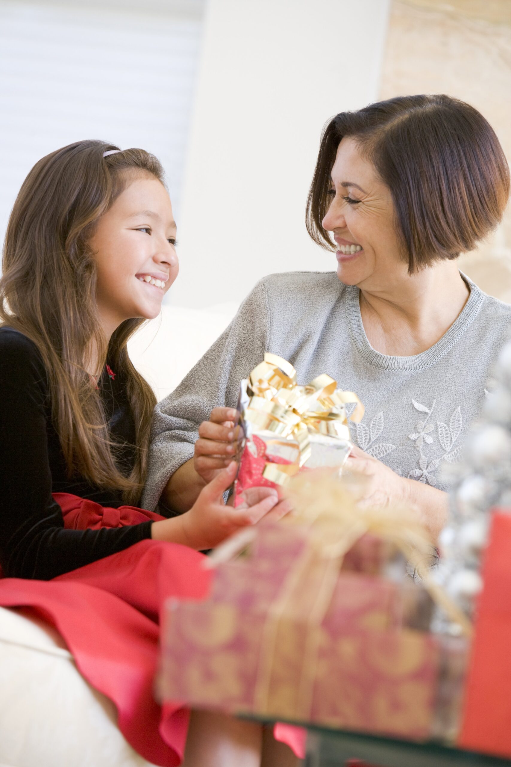 a grandmother and her daughter exchange gifts