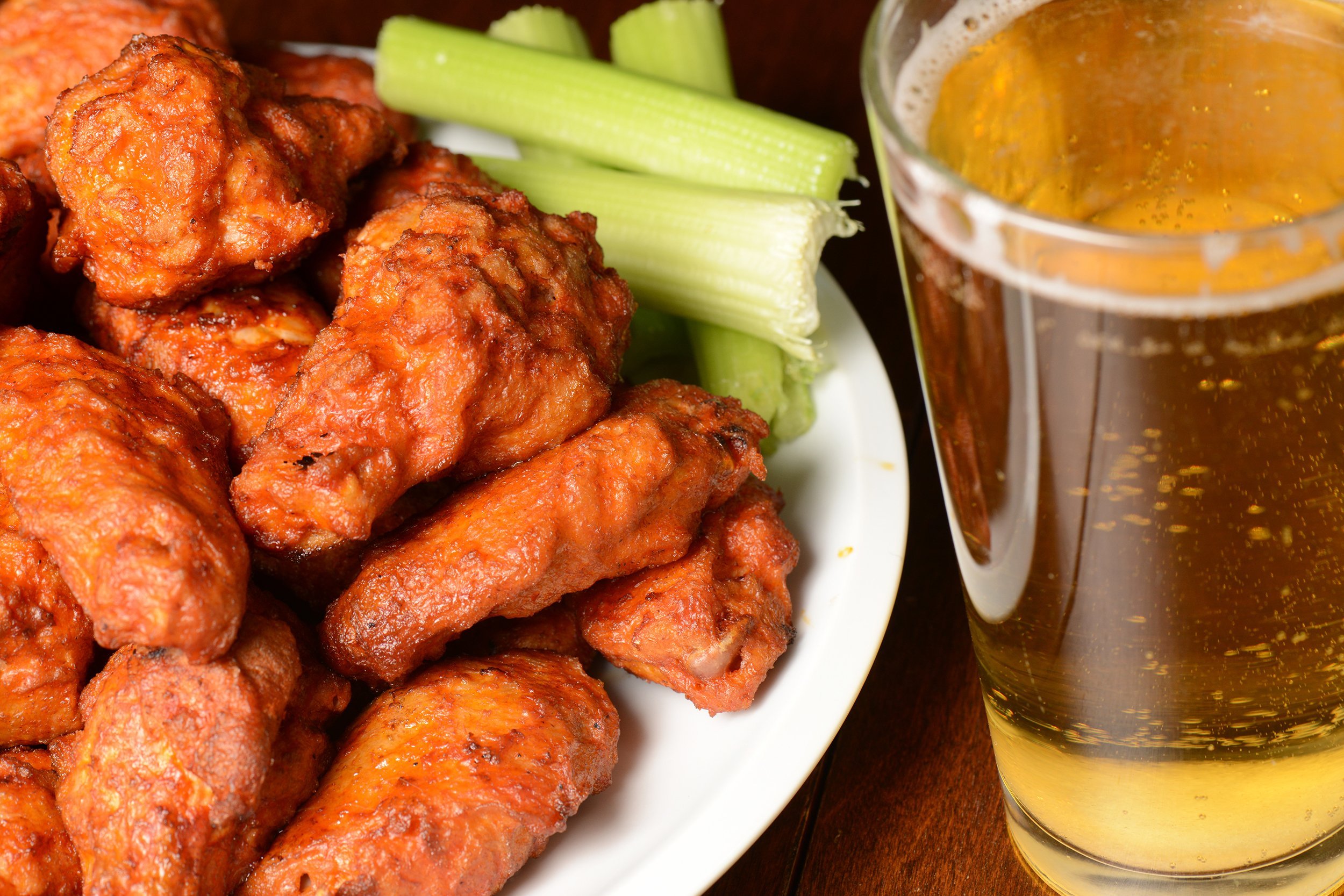 buffalo wings with celery sticks and beer
