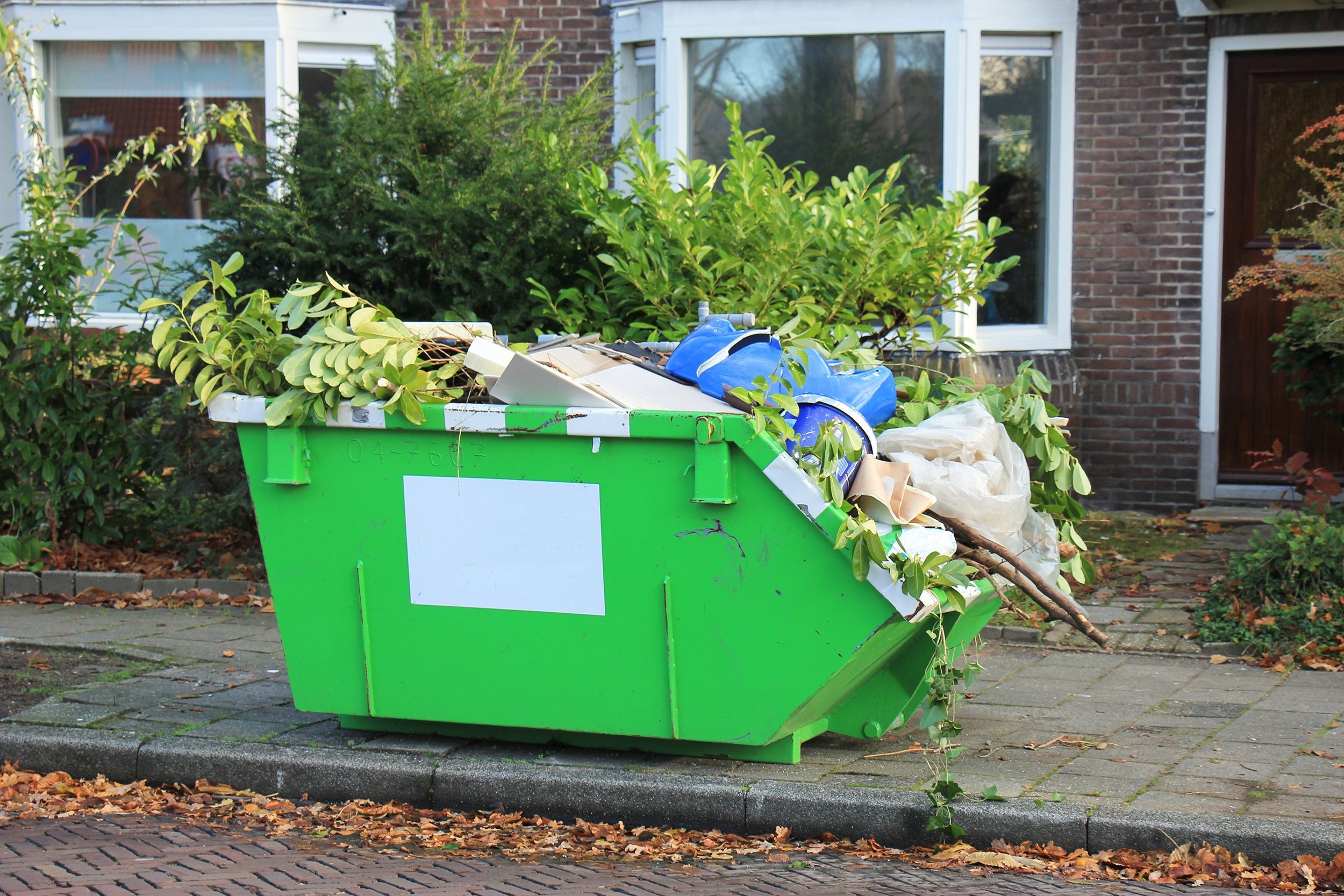 loaded dumpster in front of home