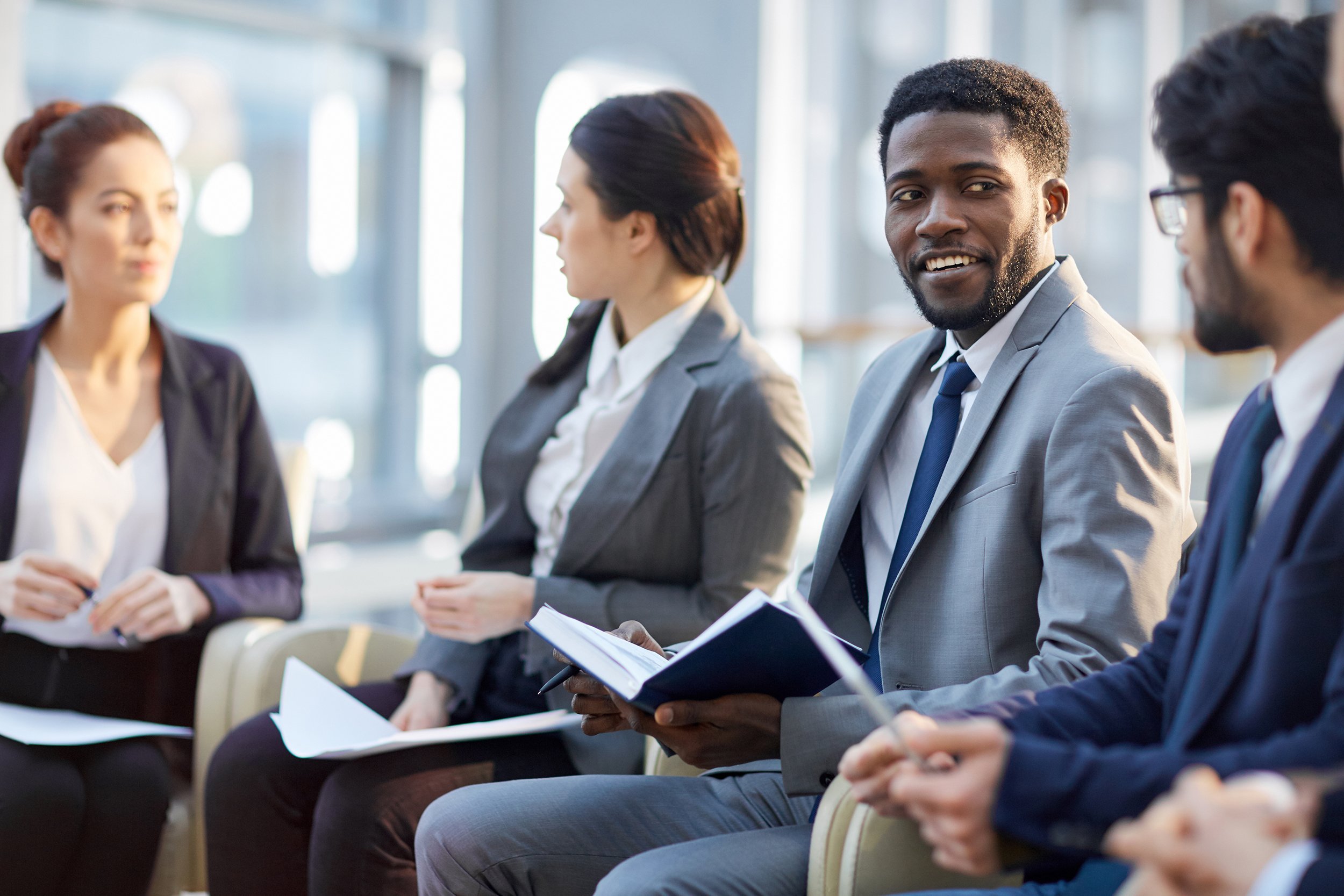 modern manager looking at companion during business training or conference