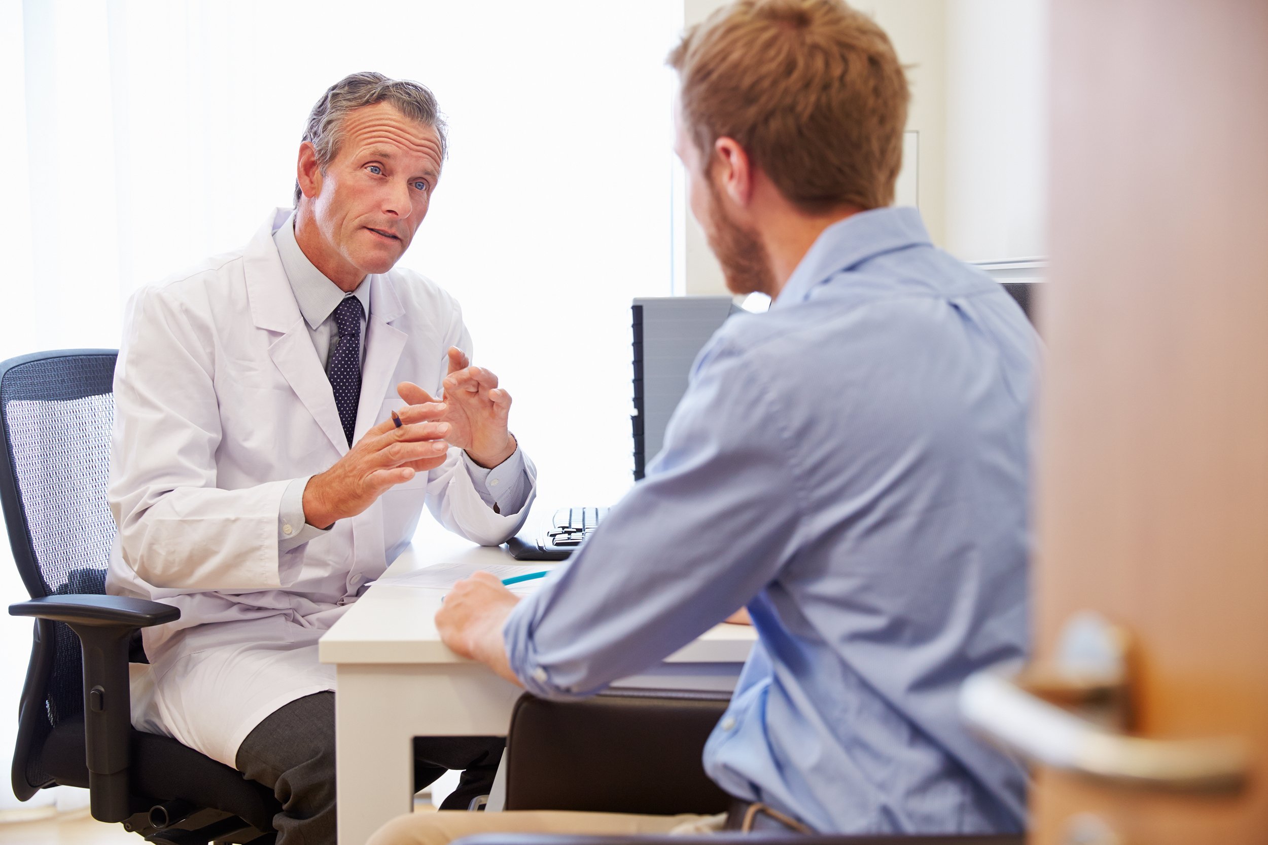 male patient having consultation with doctor in office