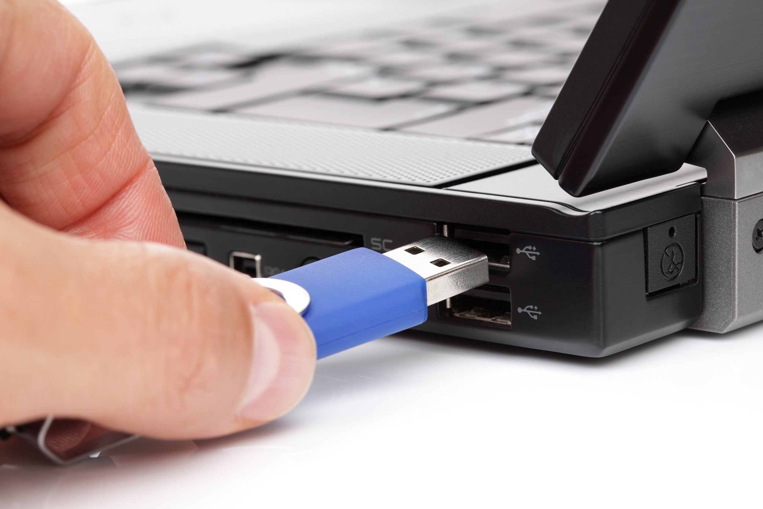 usb flash drive stick being connected to laptop