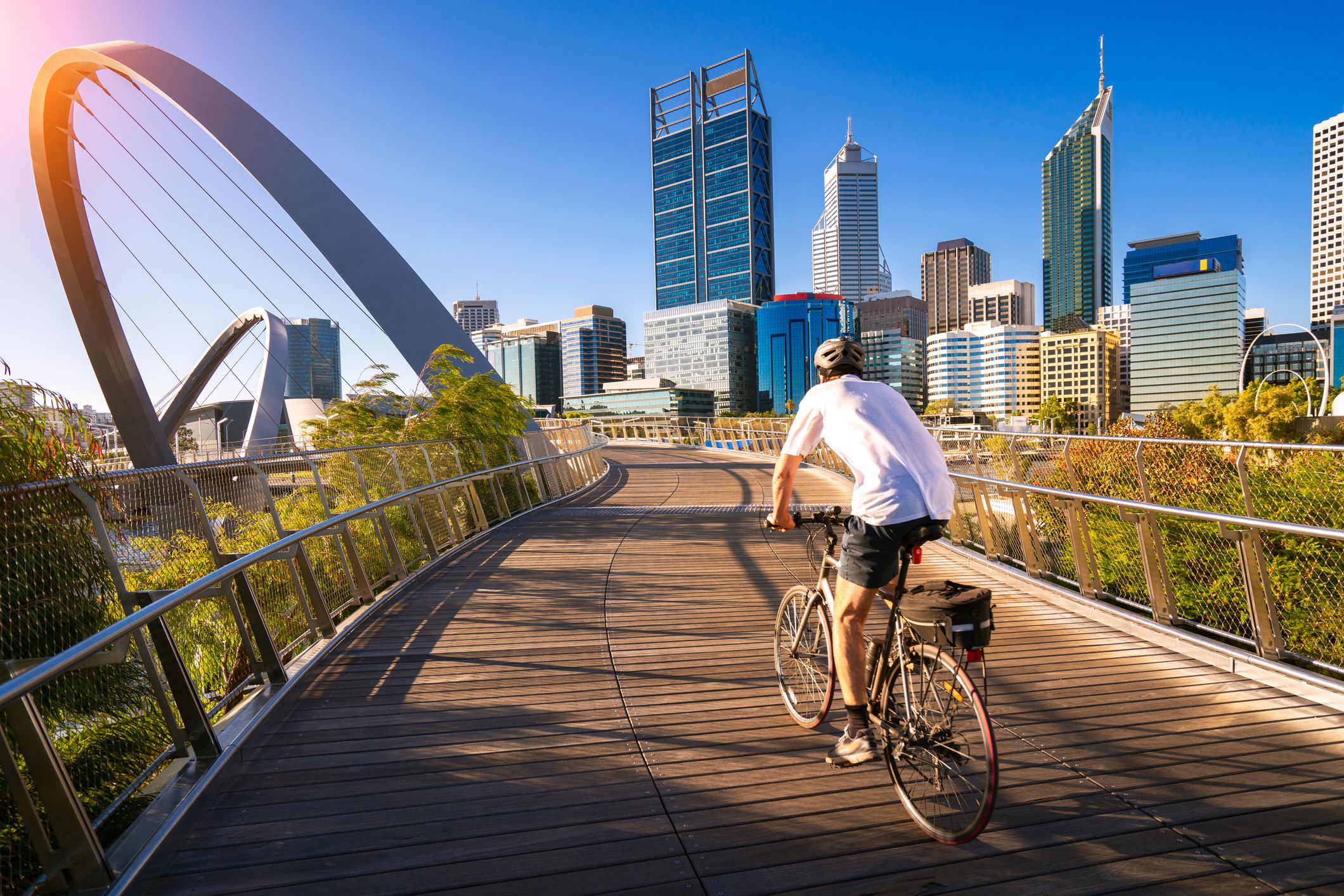 man cycling on an elizabeth bridge in Perth city