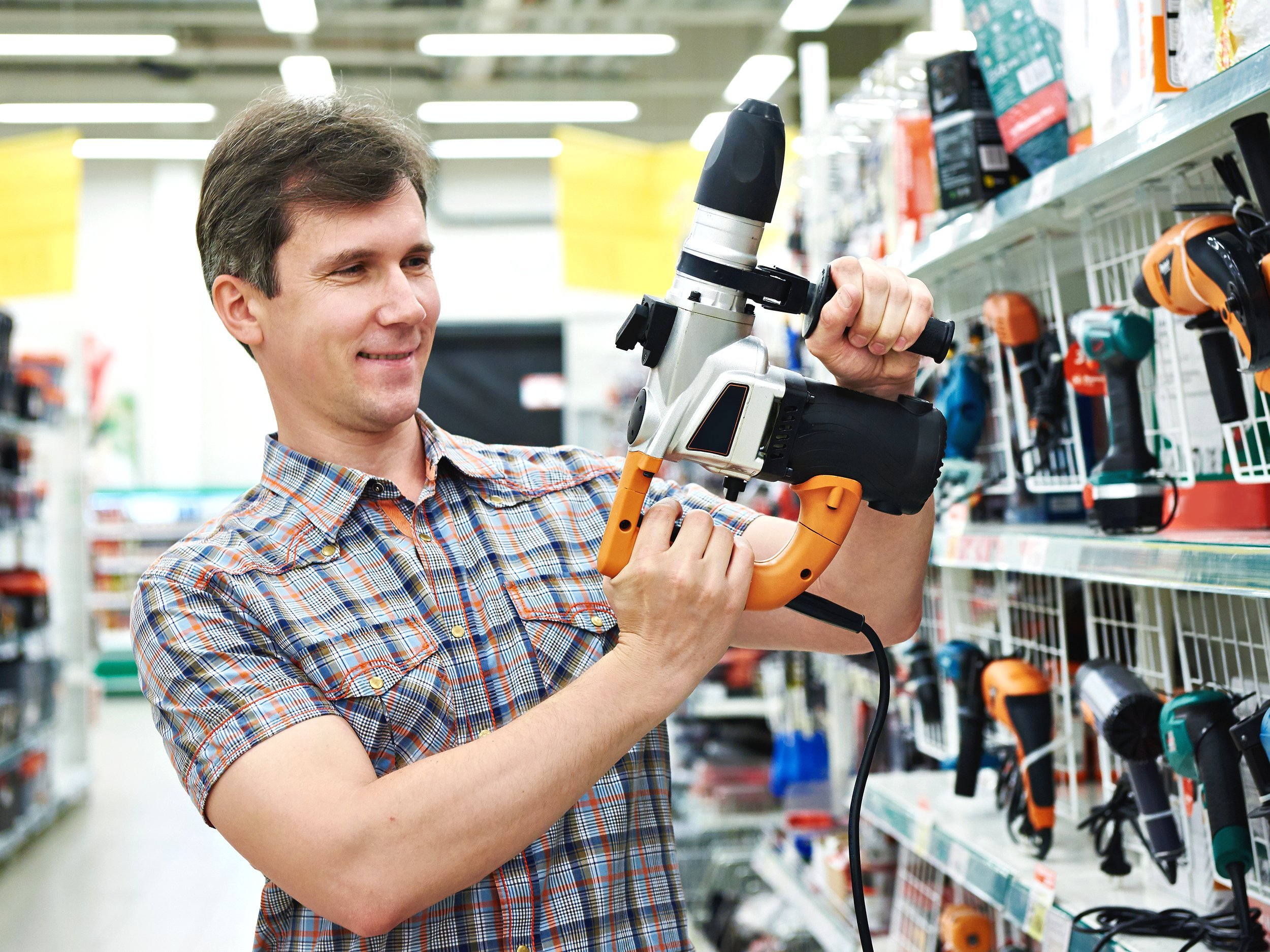 Man shopping for tool in hardware store