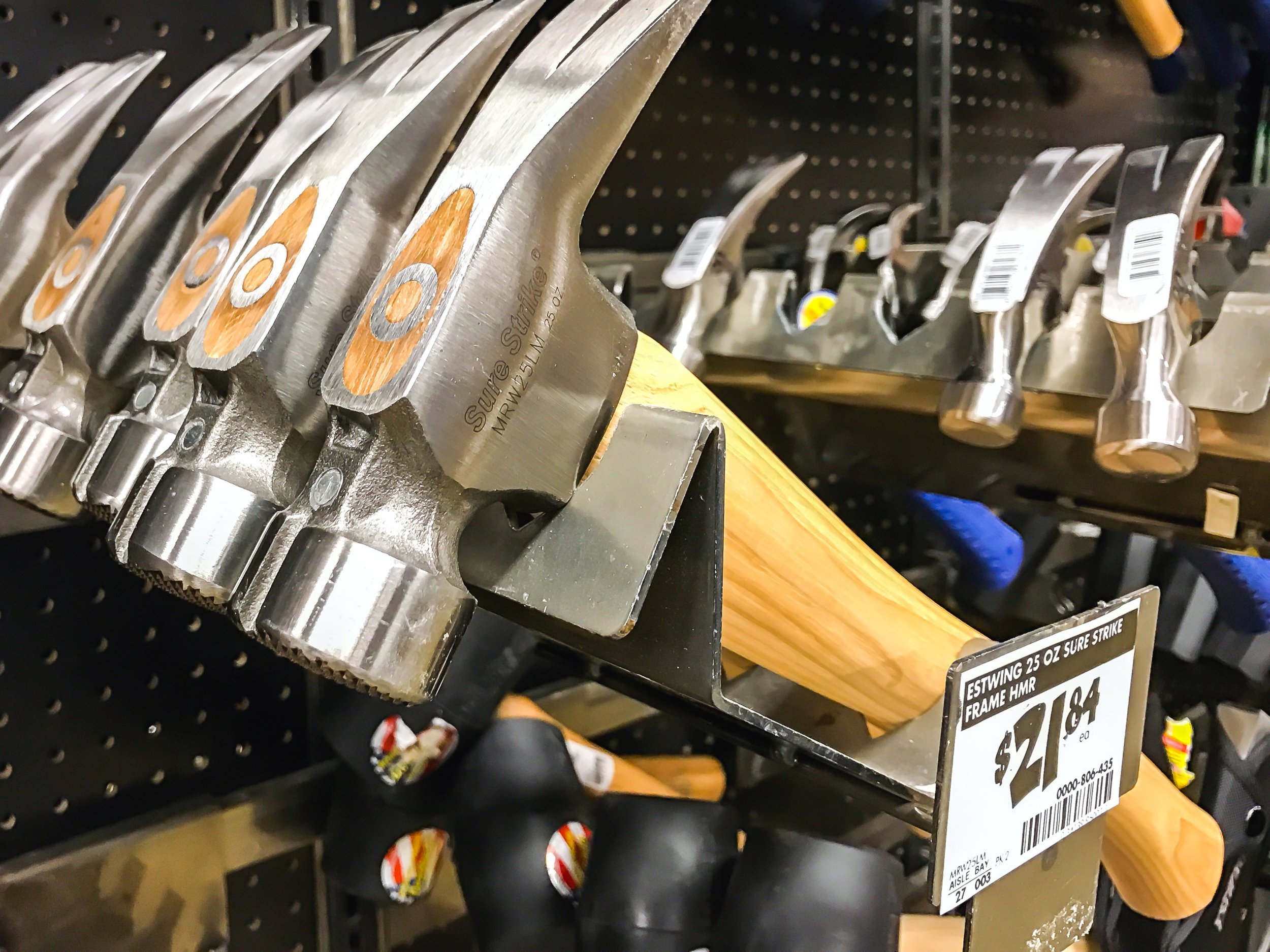 Hammers for sale hang on a rack in a Home Depot store