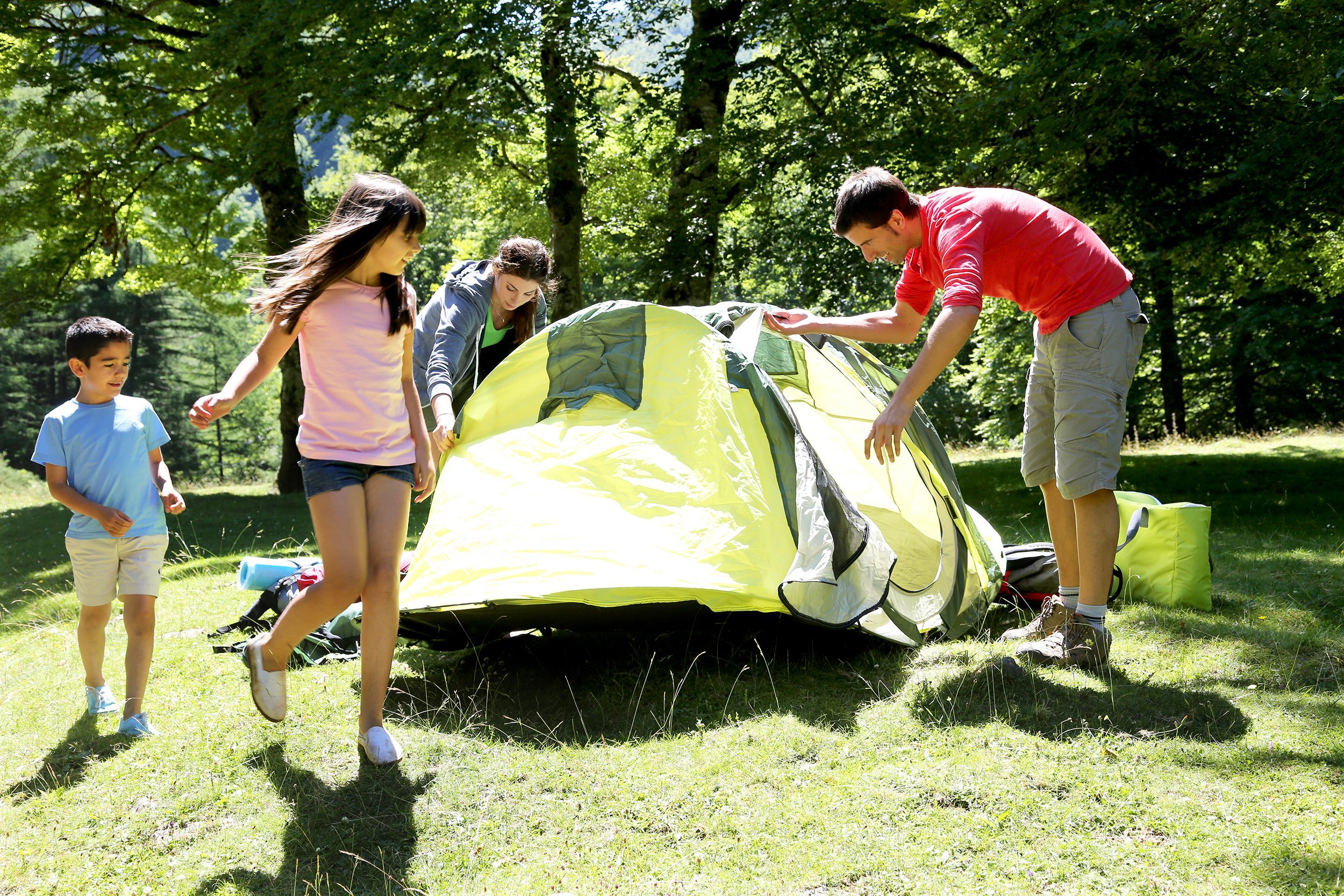 family doing camping in the forest