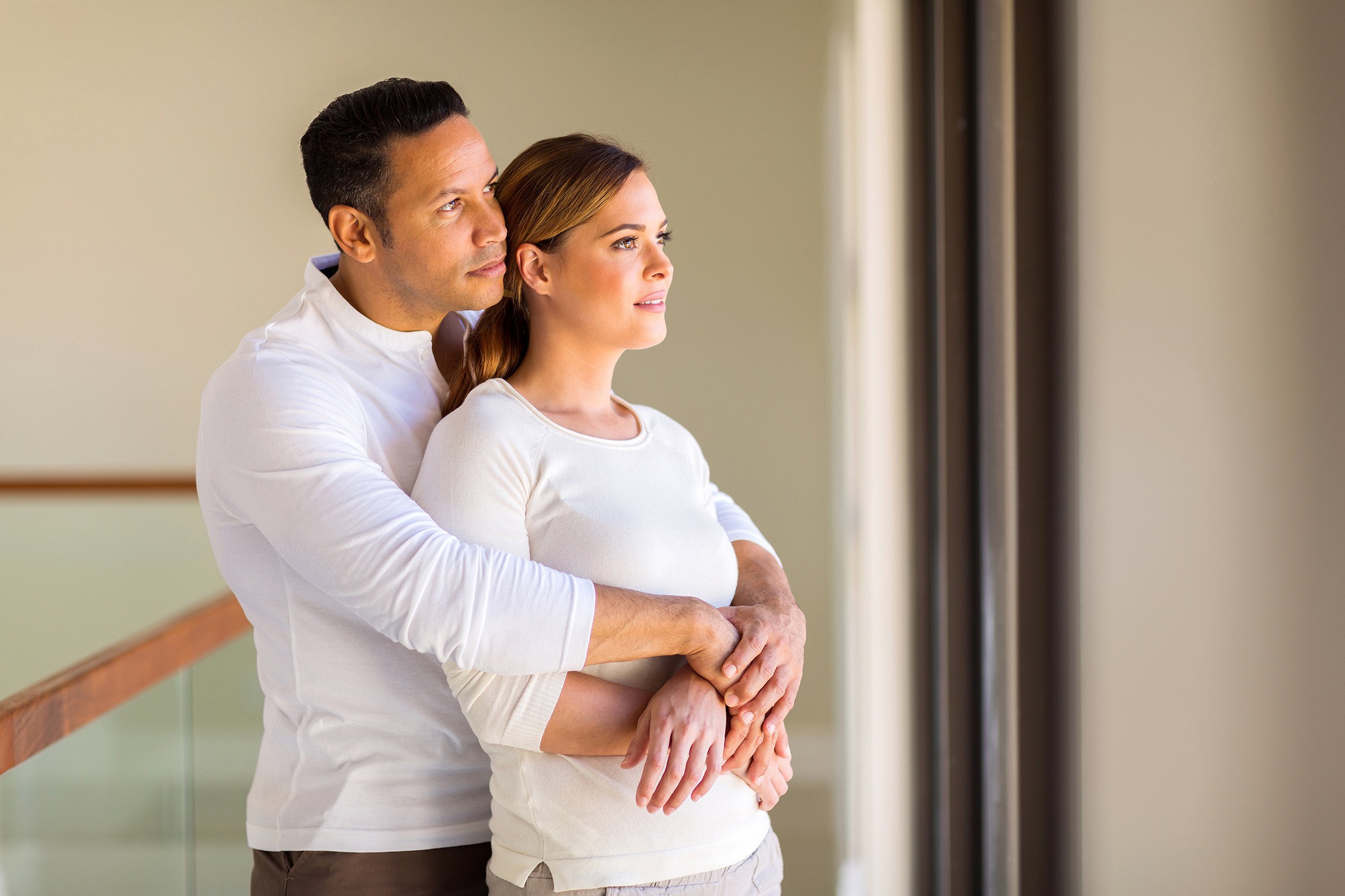 thoughtful mid age couple in their new home