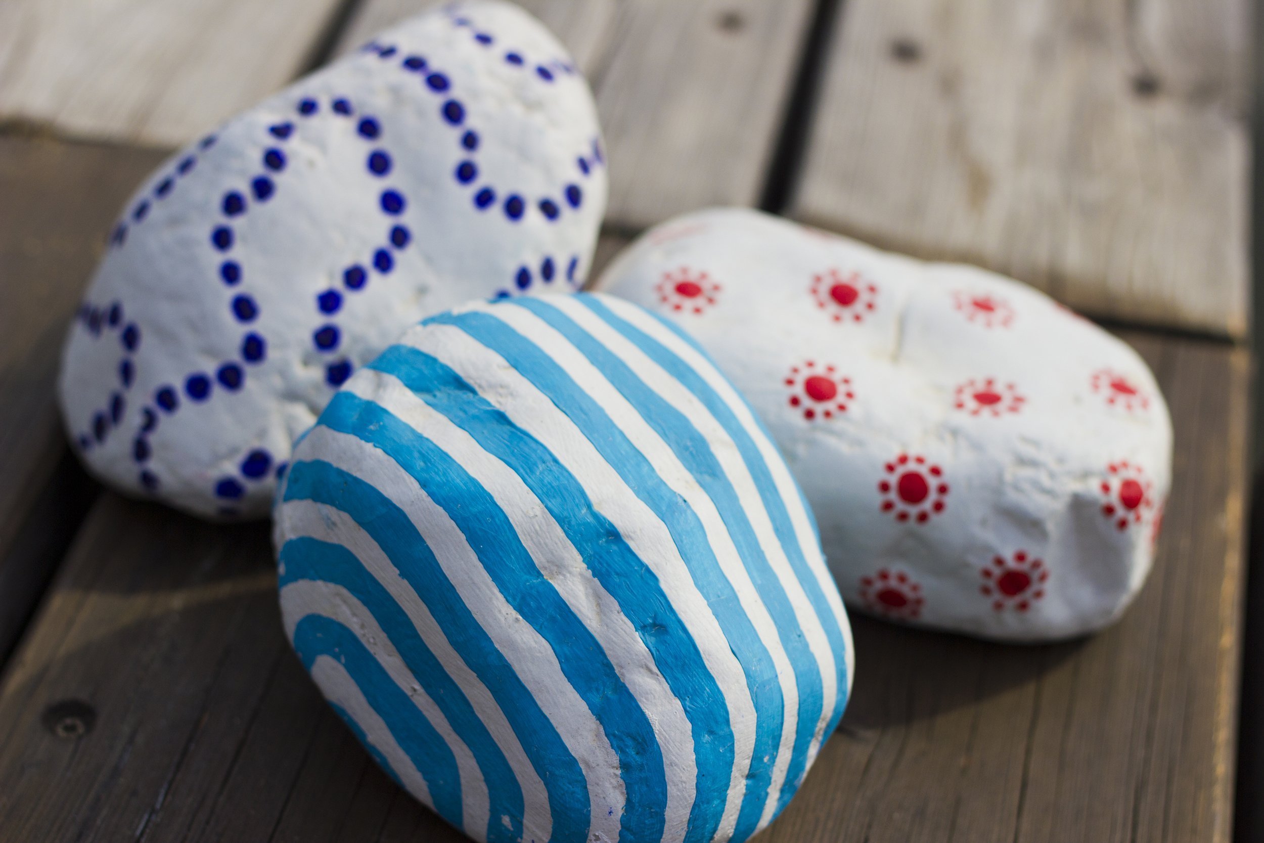 three decor colored stones on the old wooden floor