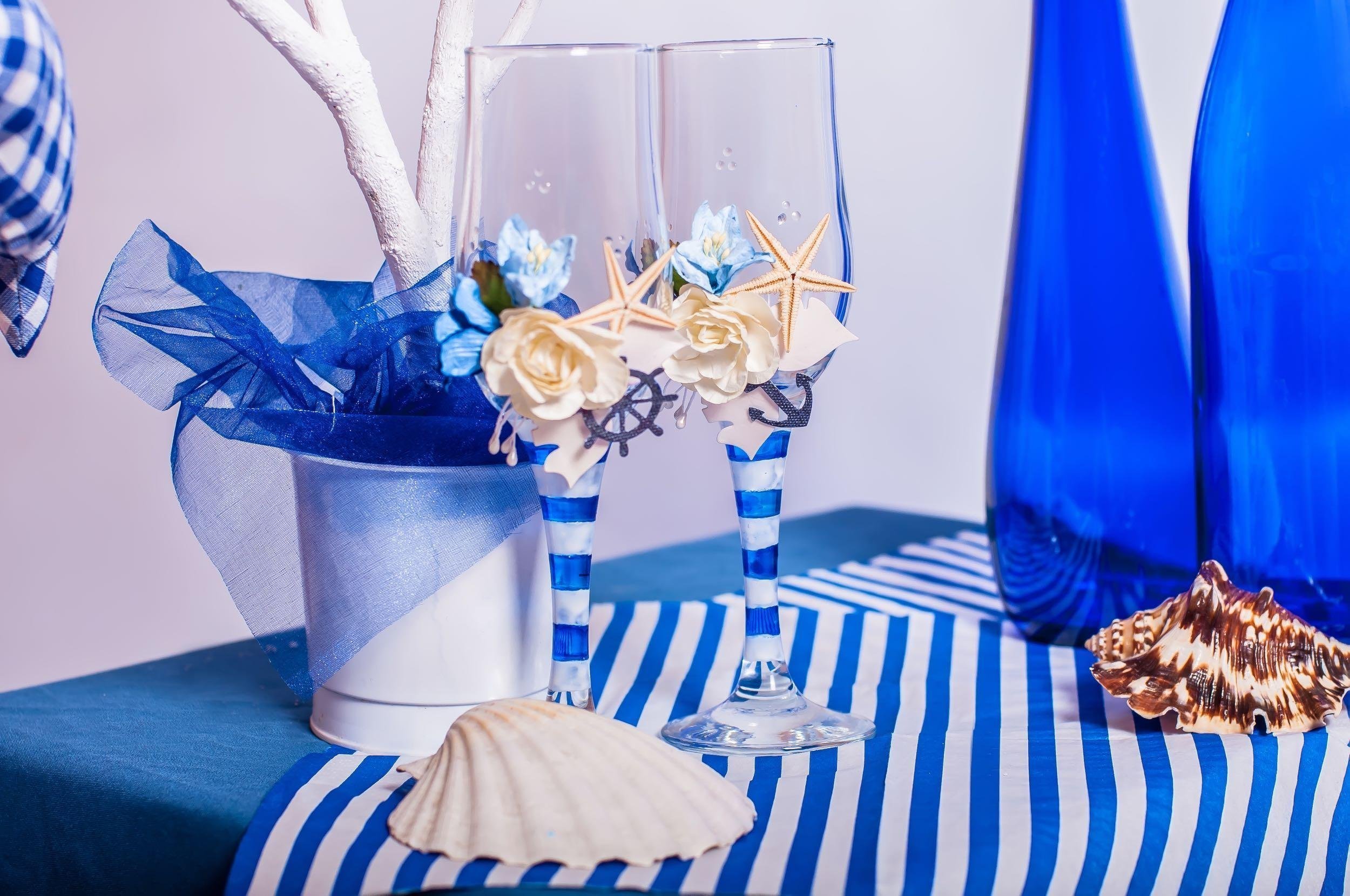 decoration on the marine theme with seashells, fish, bottles and glasses