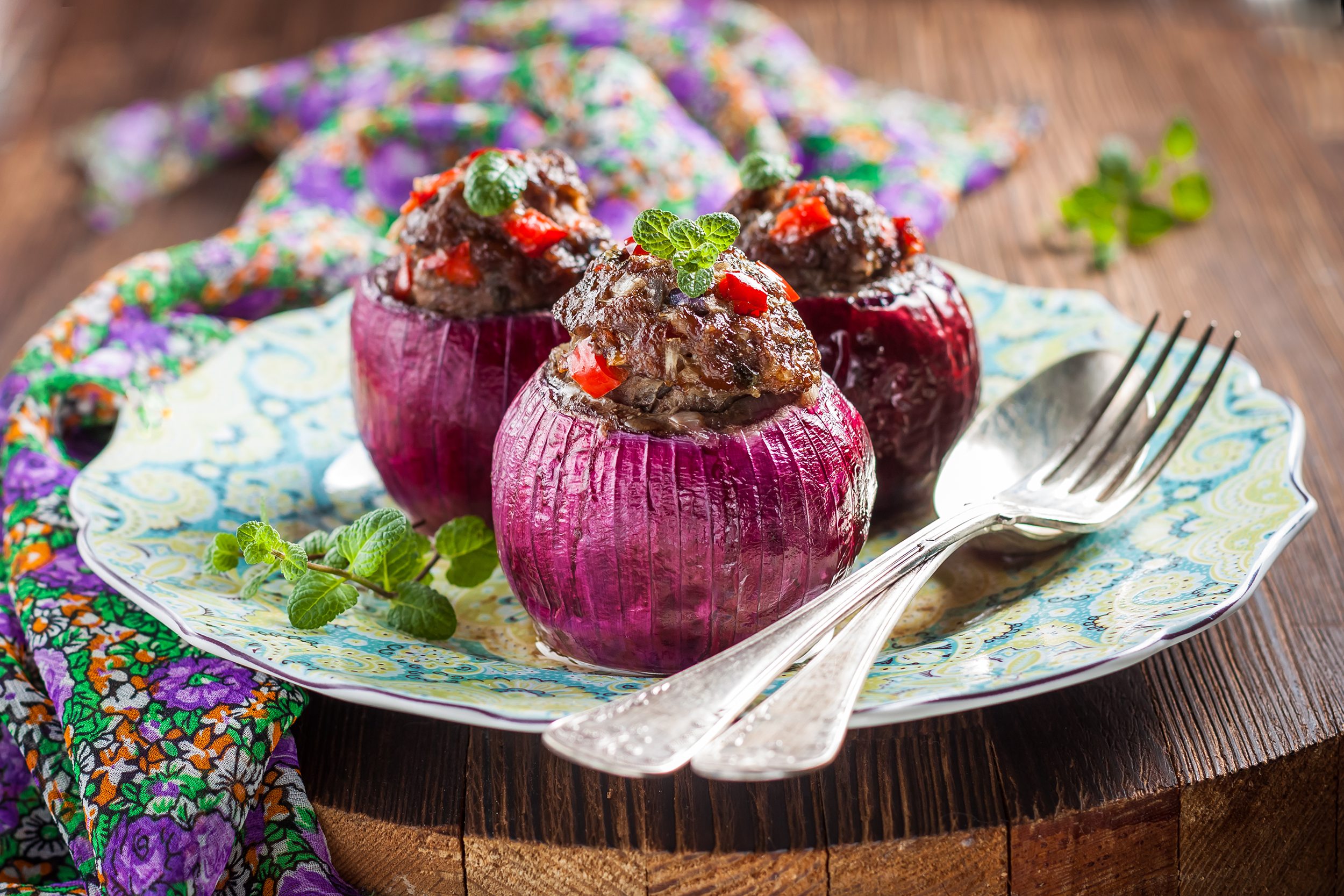 Meat stuffed onions on a cutting board