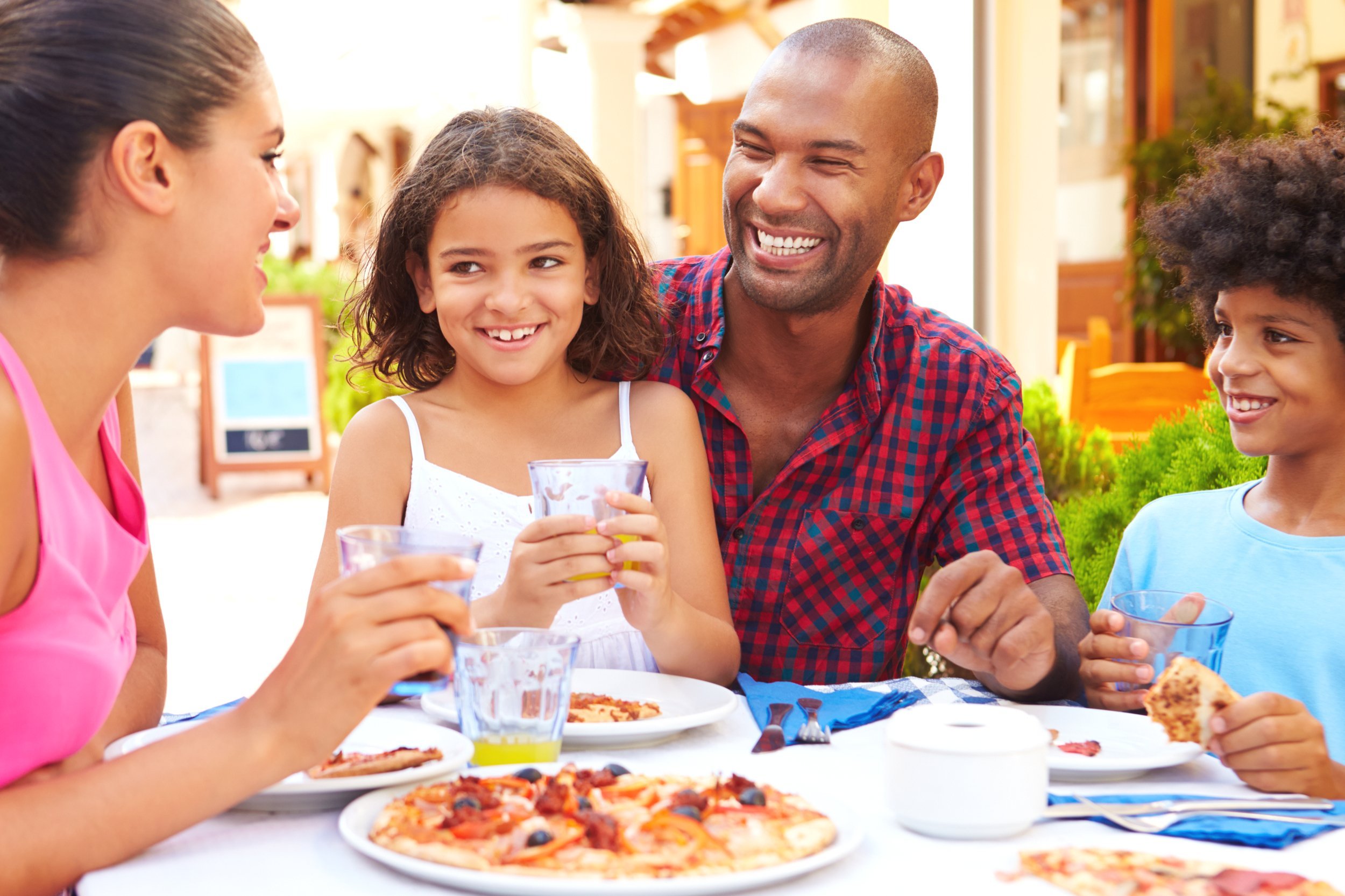 Family eating at outdoor restaurant together