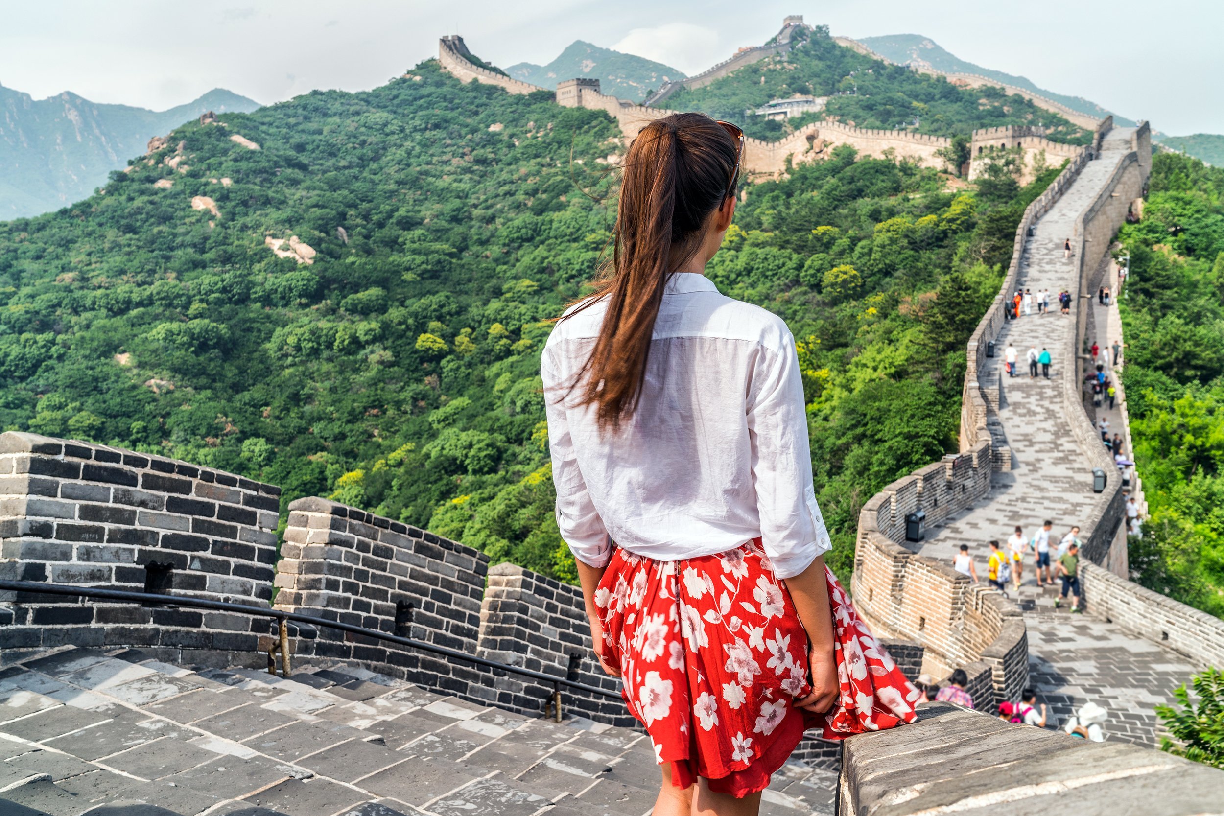 tourist from behind looking at view of Great Wall of China