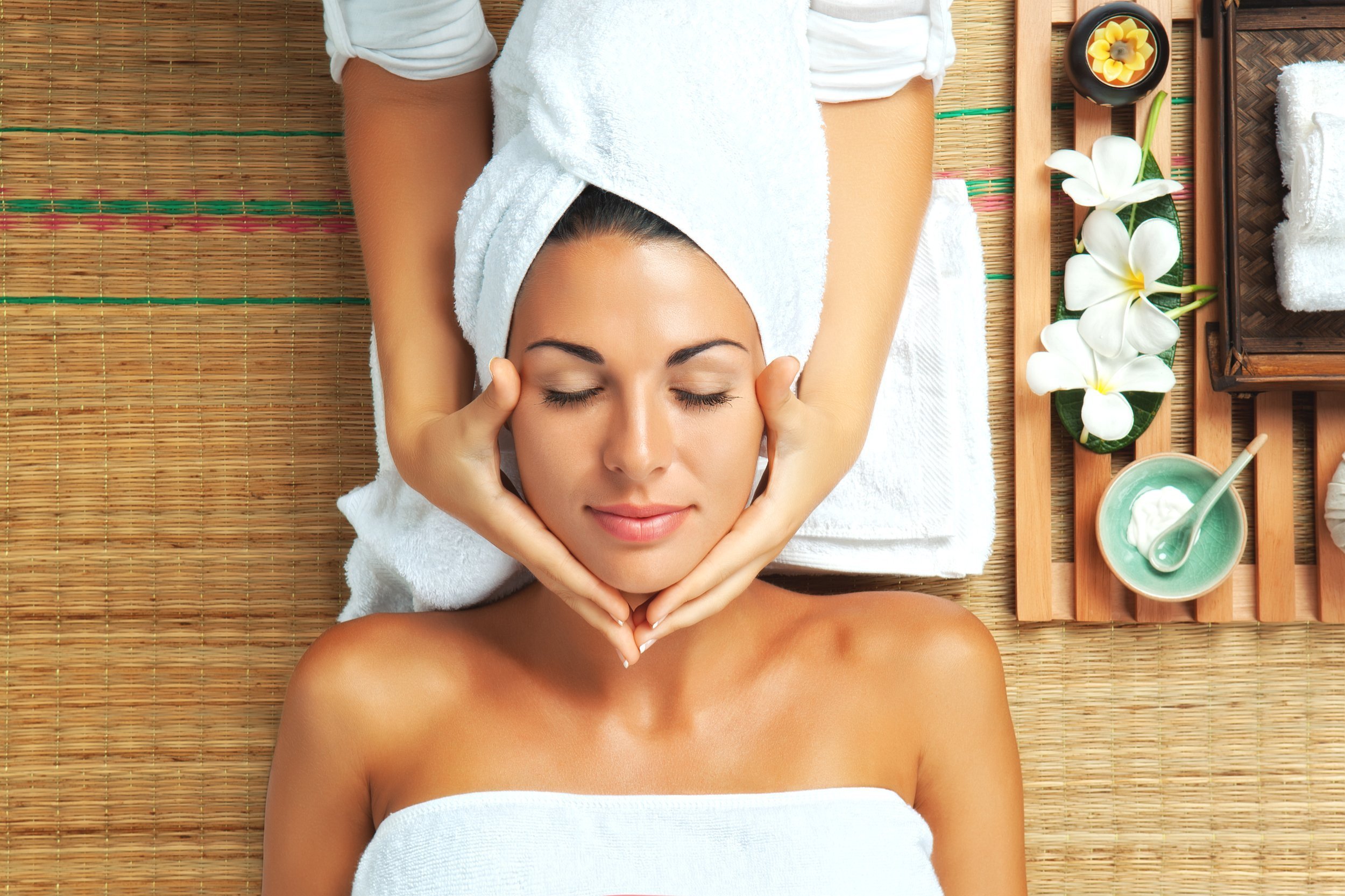 woman getting a facial massage at a spa