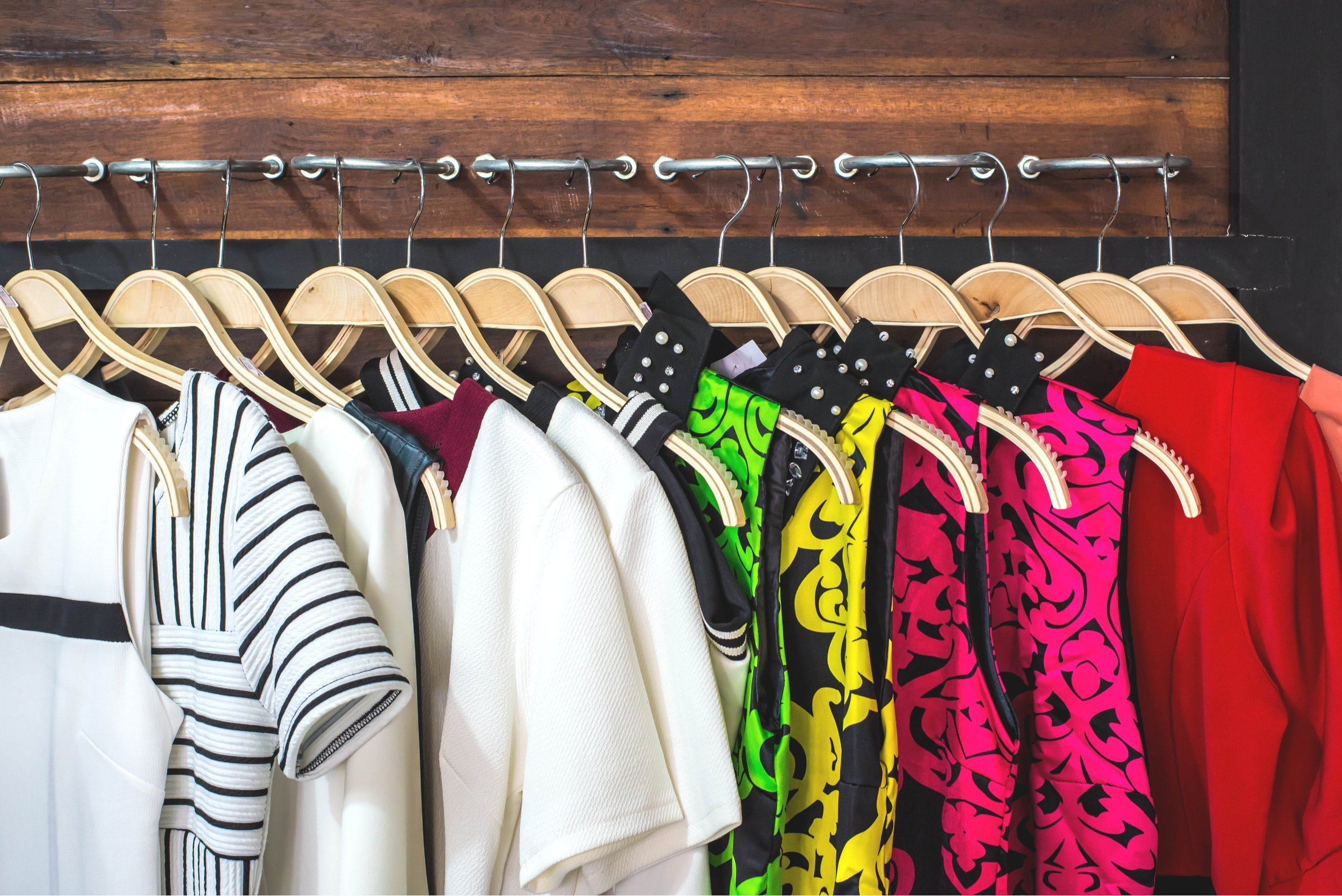 many dresses on hangers in the dressing room