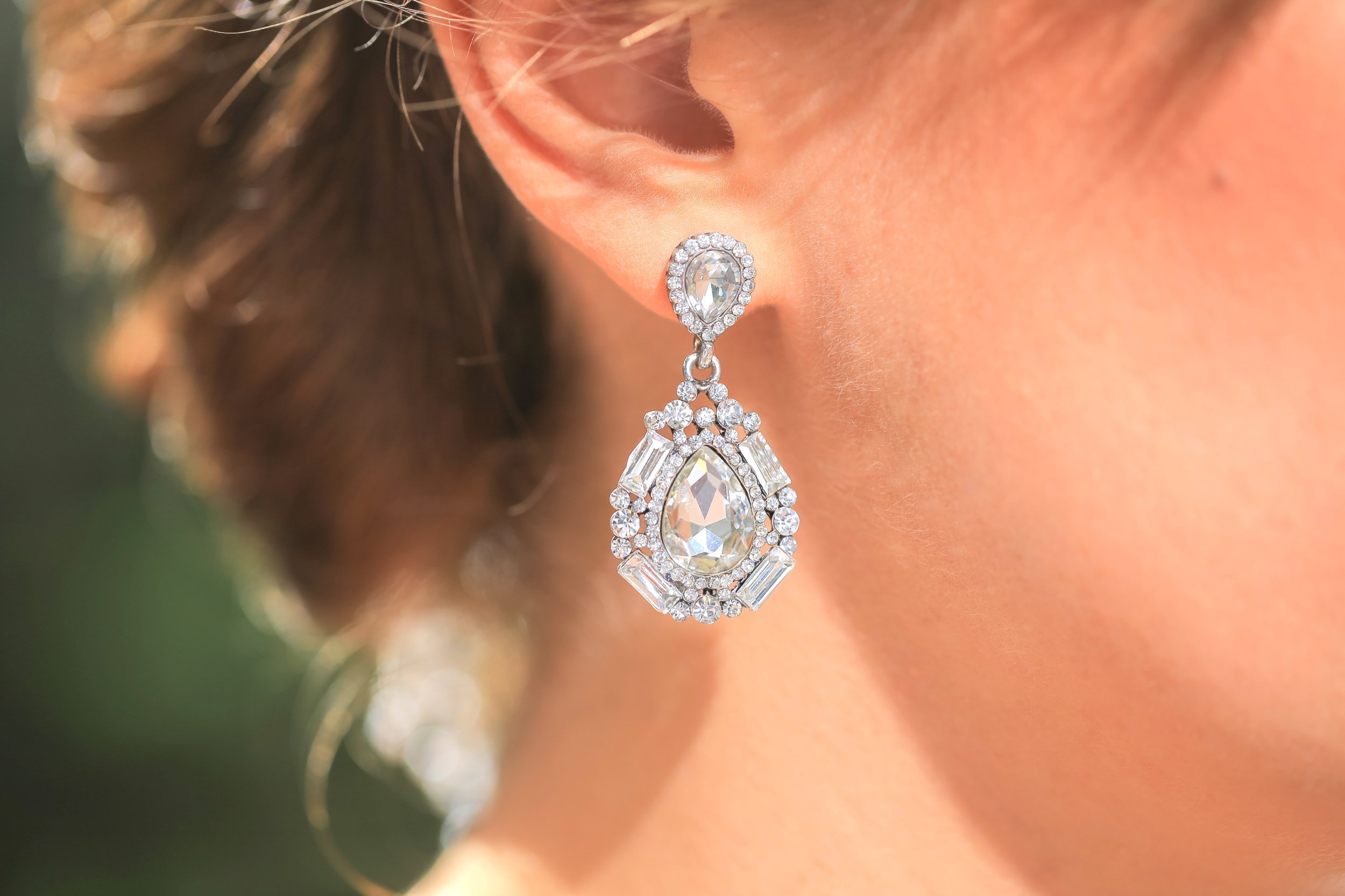 closeup of diamond earring on a woman