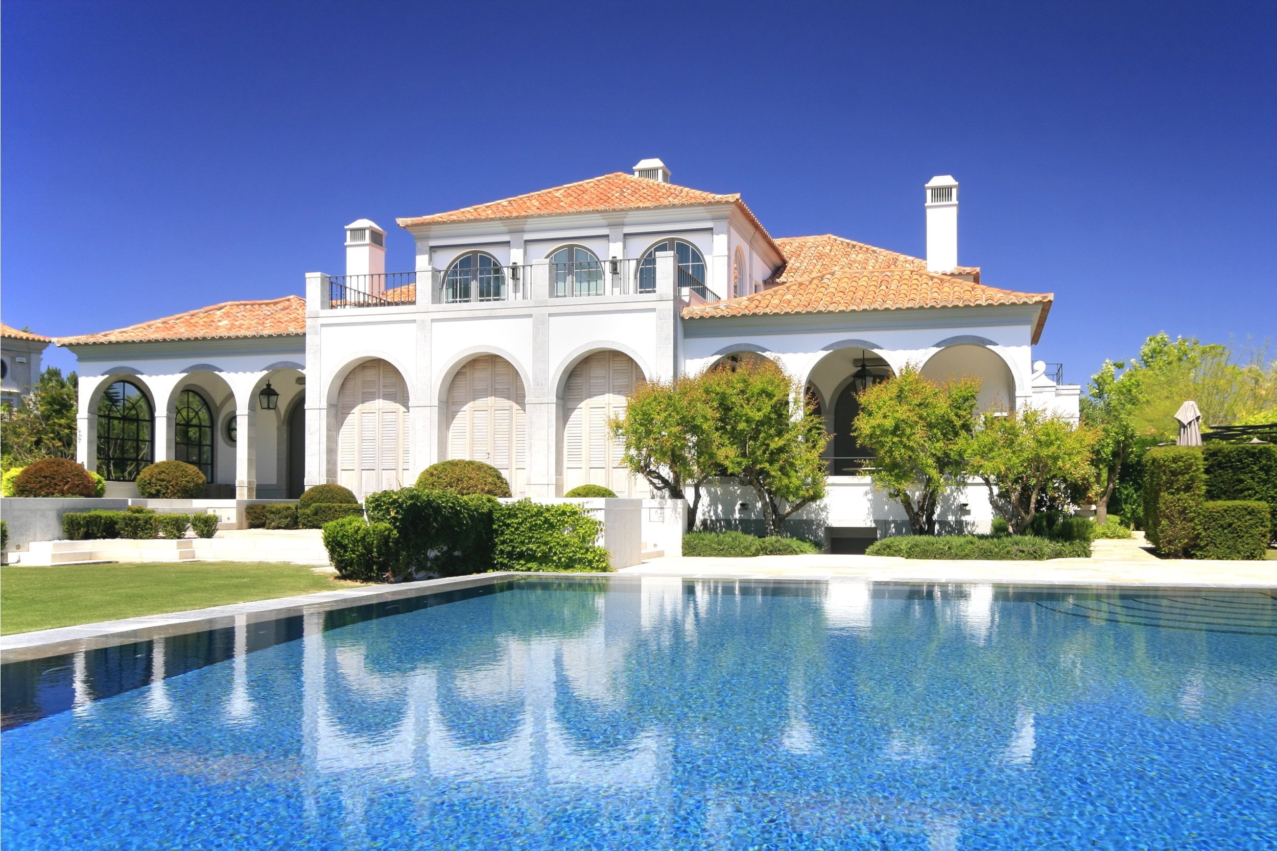 a modern and luxurious mansion with pool