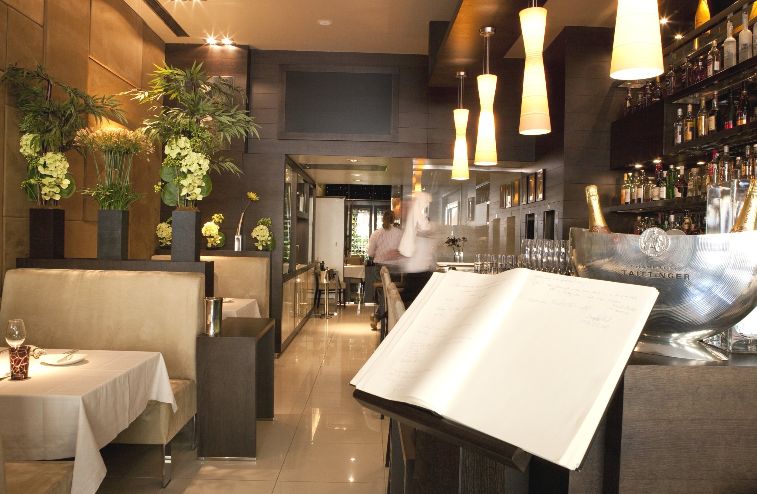 interior of a fancy restaurant with booths and view of the bar