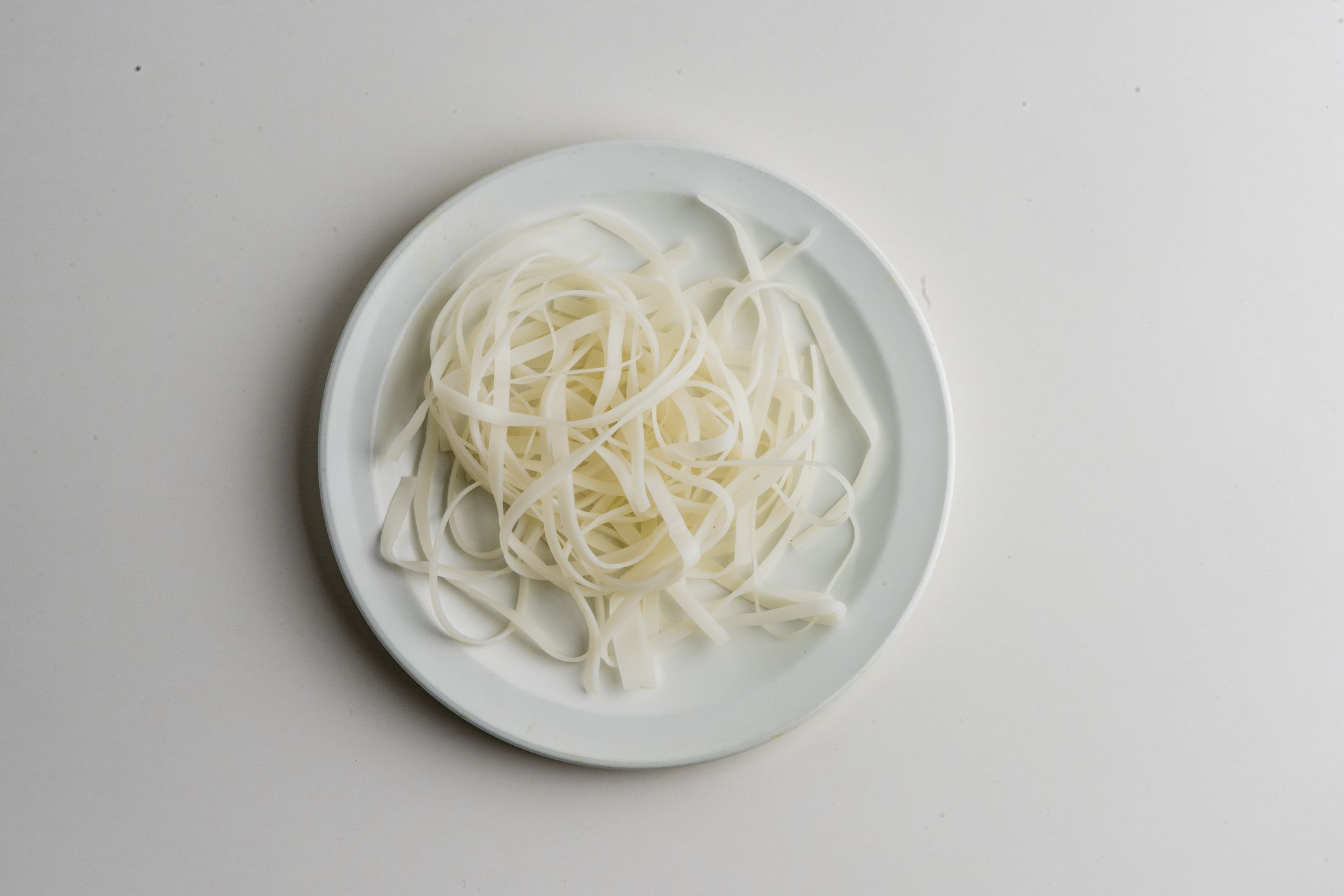 Rice noodles. Ingredients for restaurant cooking from farmers markets. Photographed on white background. Fresh Fruits & vegetables from farmers market. Classic ingredients, garnishes used in cooking. Meats, veggies, herbs & spices.