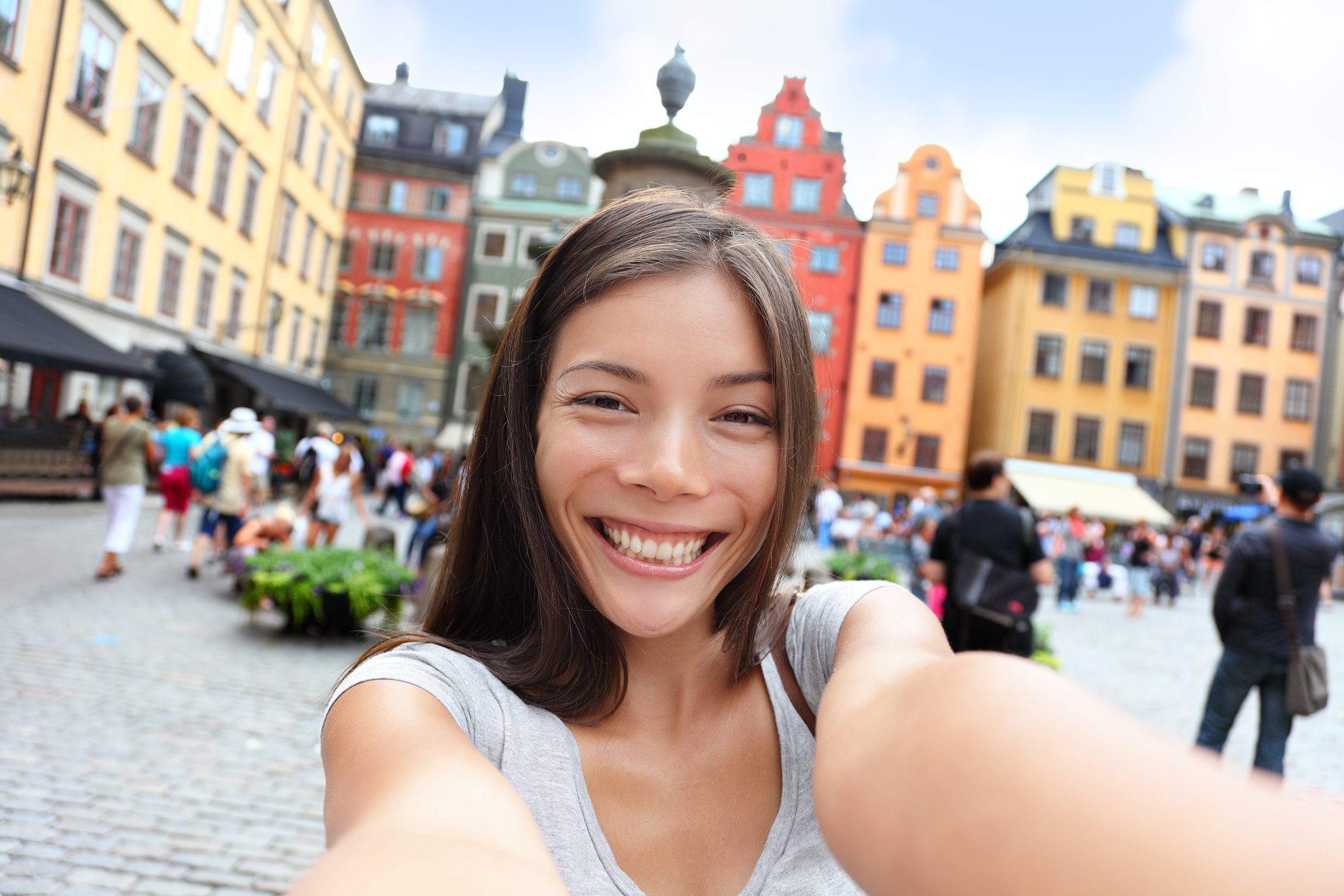 Asian woman taking self portrait selfie photo on Europe travel