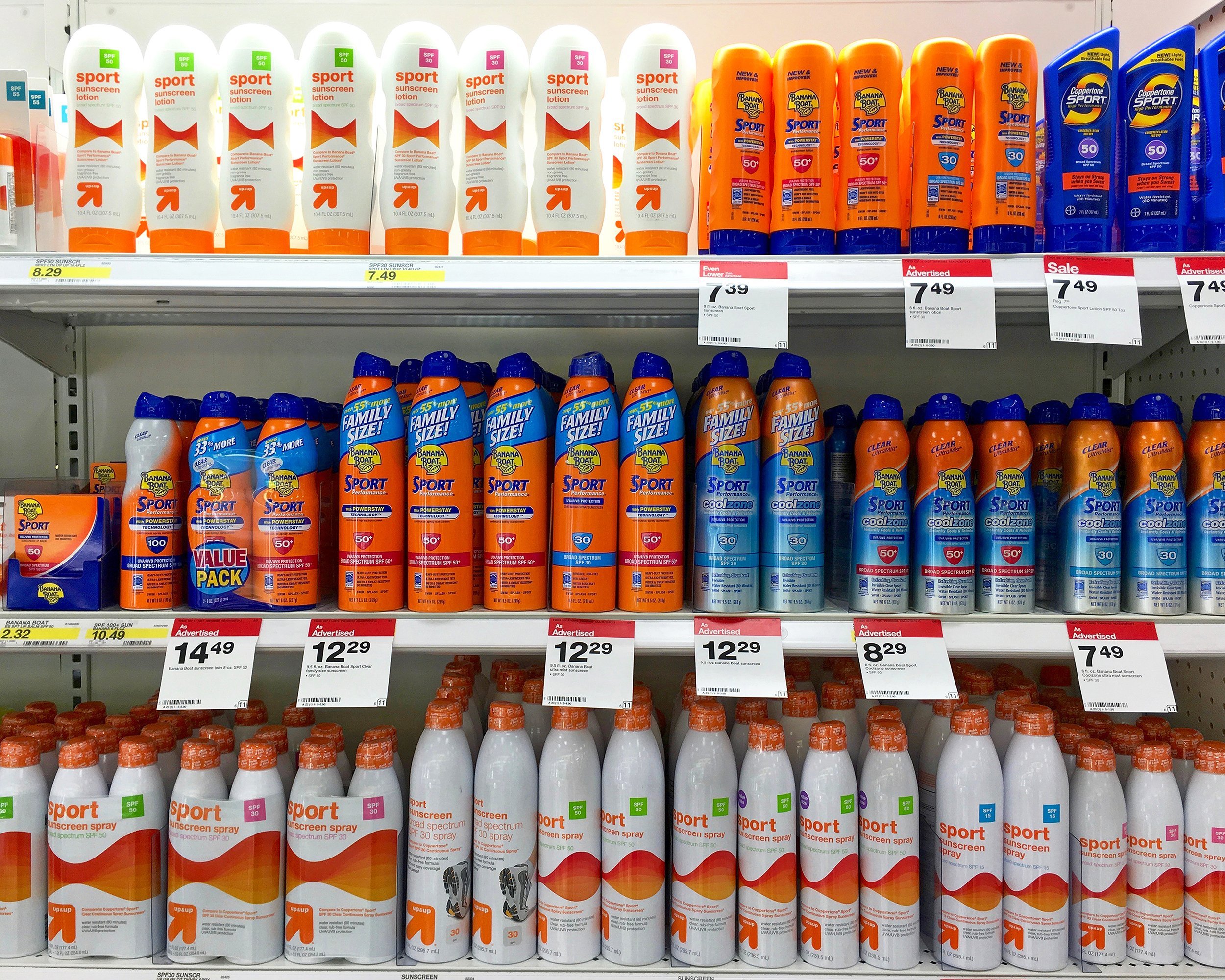 store shelf with bottles of varies brands of sunscreen products