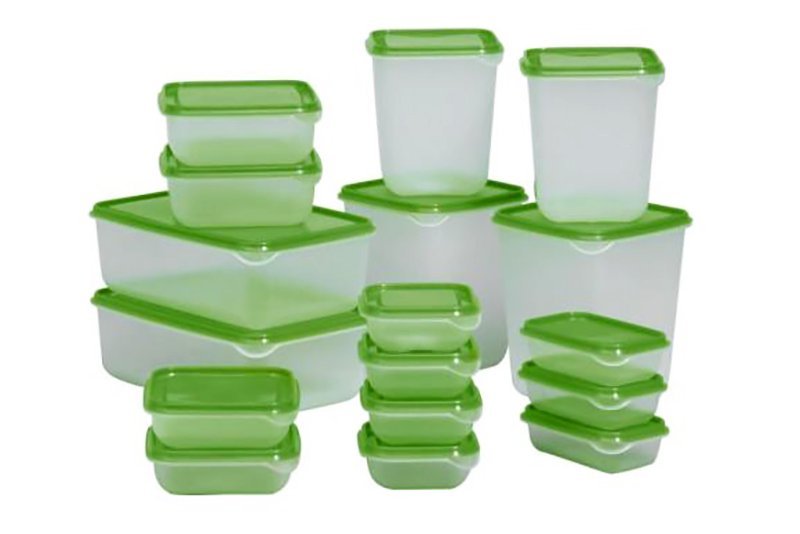 Variety of plastic food containers with green lids
