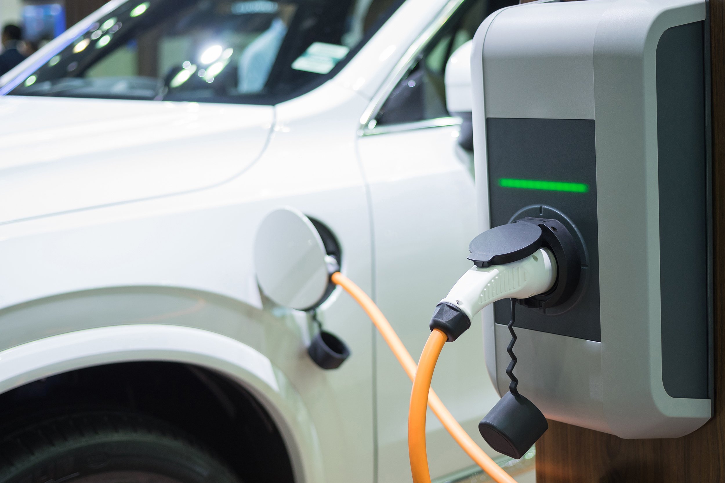 charging an electric car with the power cable supply plugged in