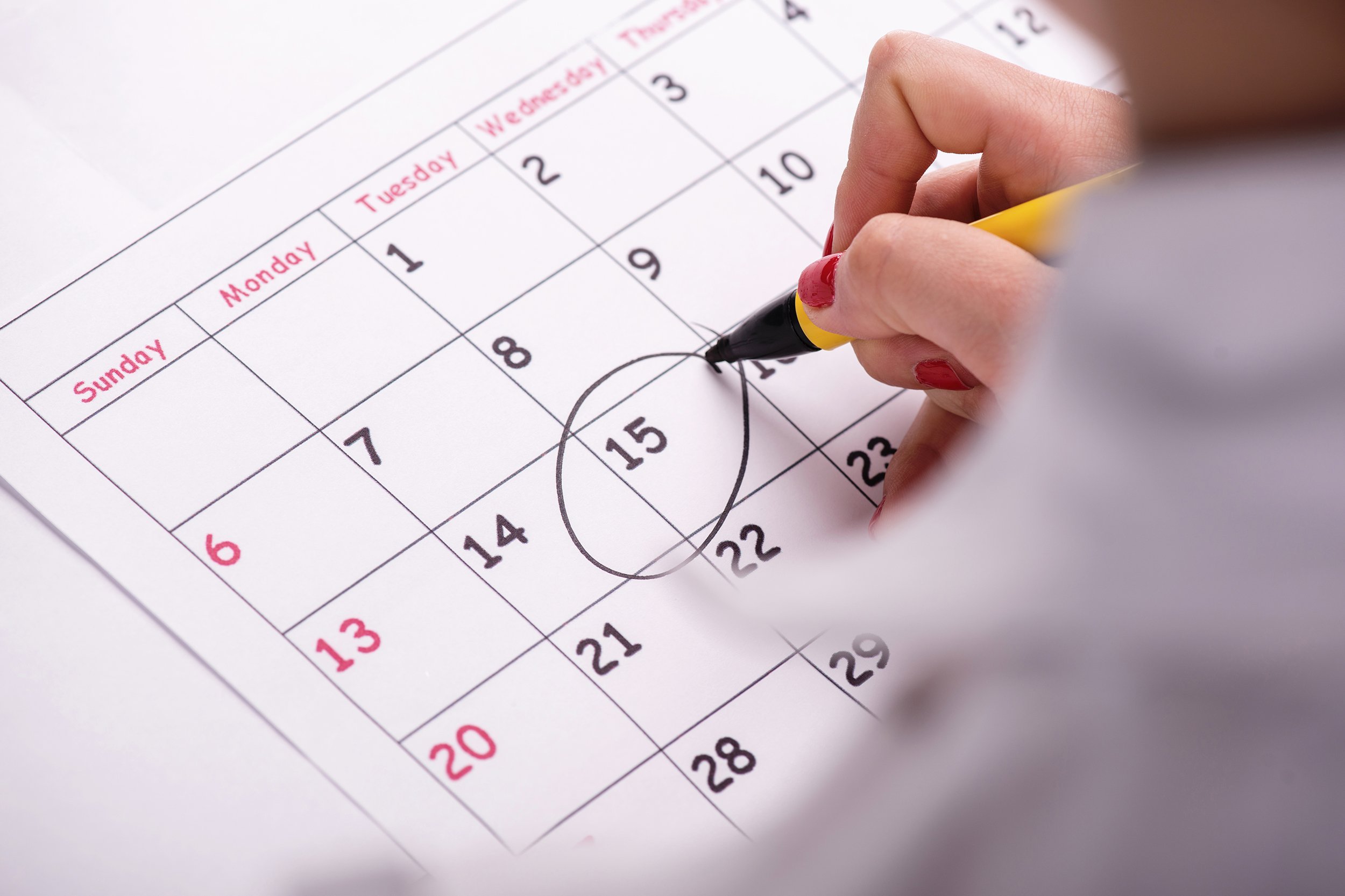 woman writing on calendar