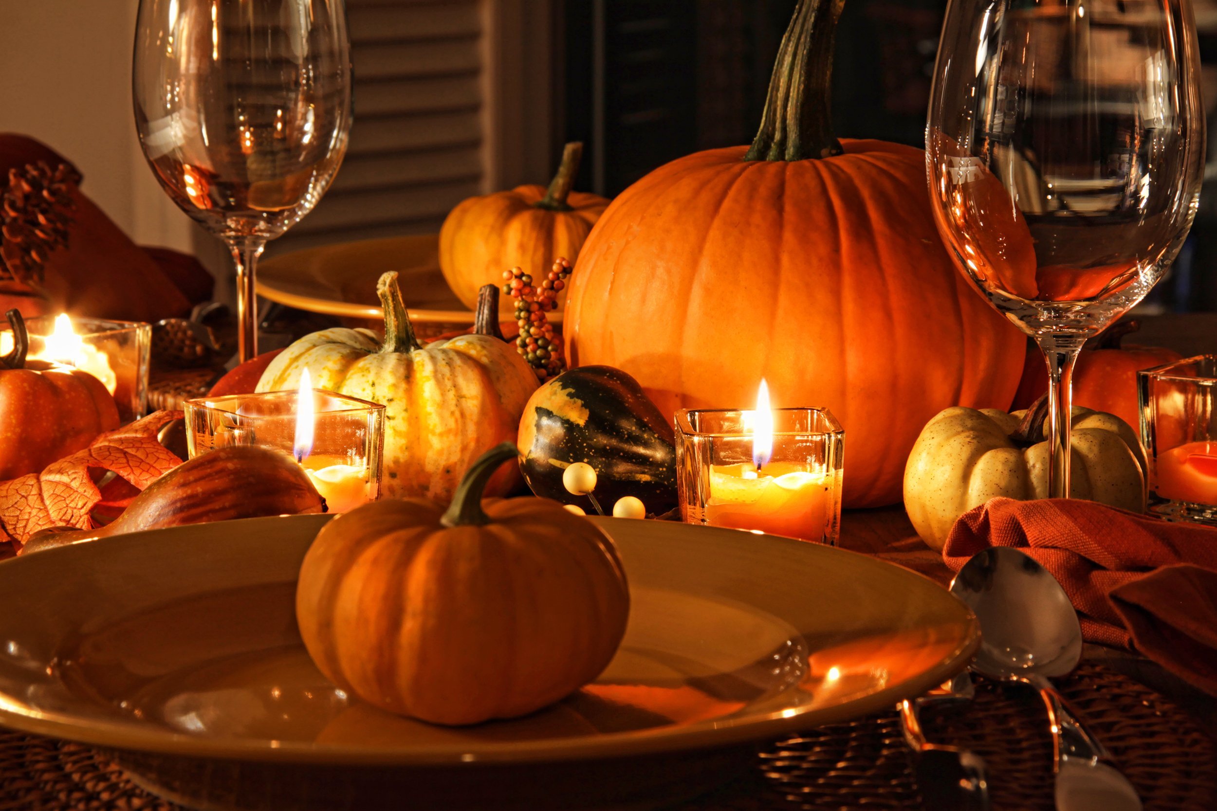 autumn place settings with pumpkins and candles