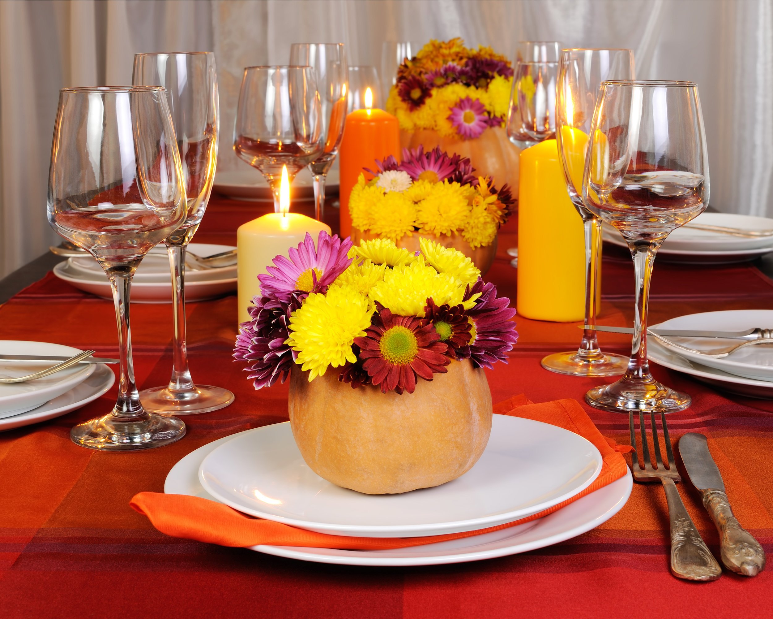 Autumn flowers in a pumpkin vase on table