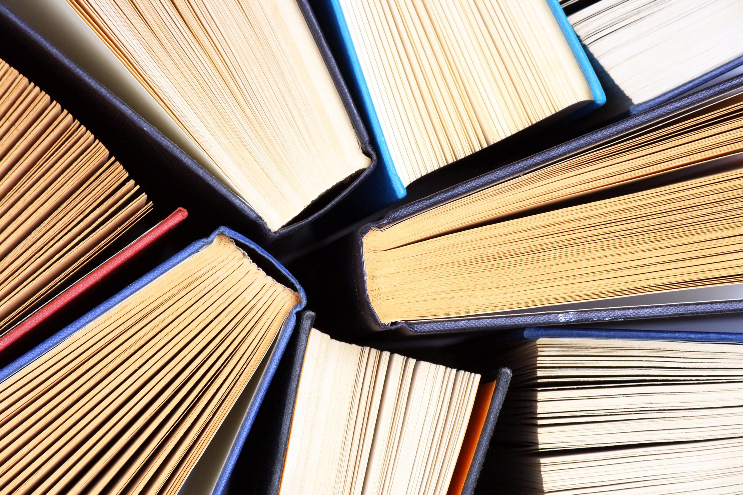 old and used hardback books, seen from above