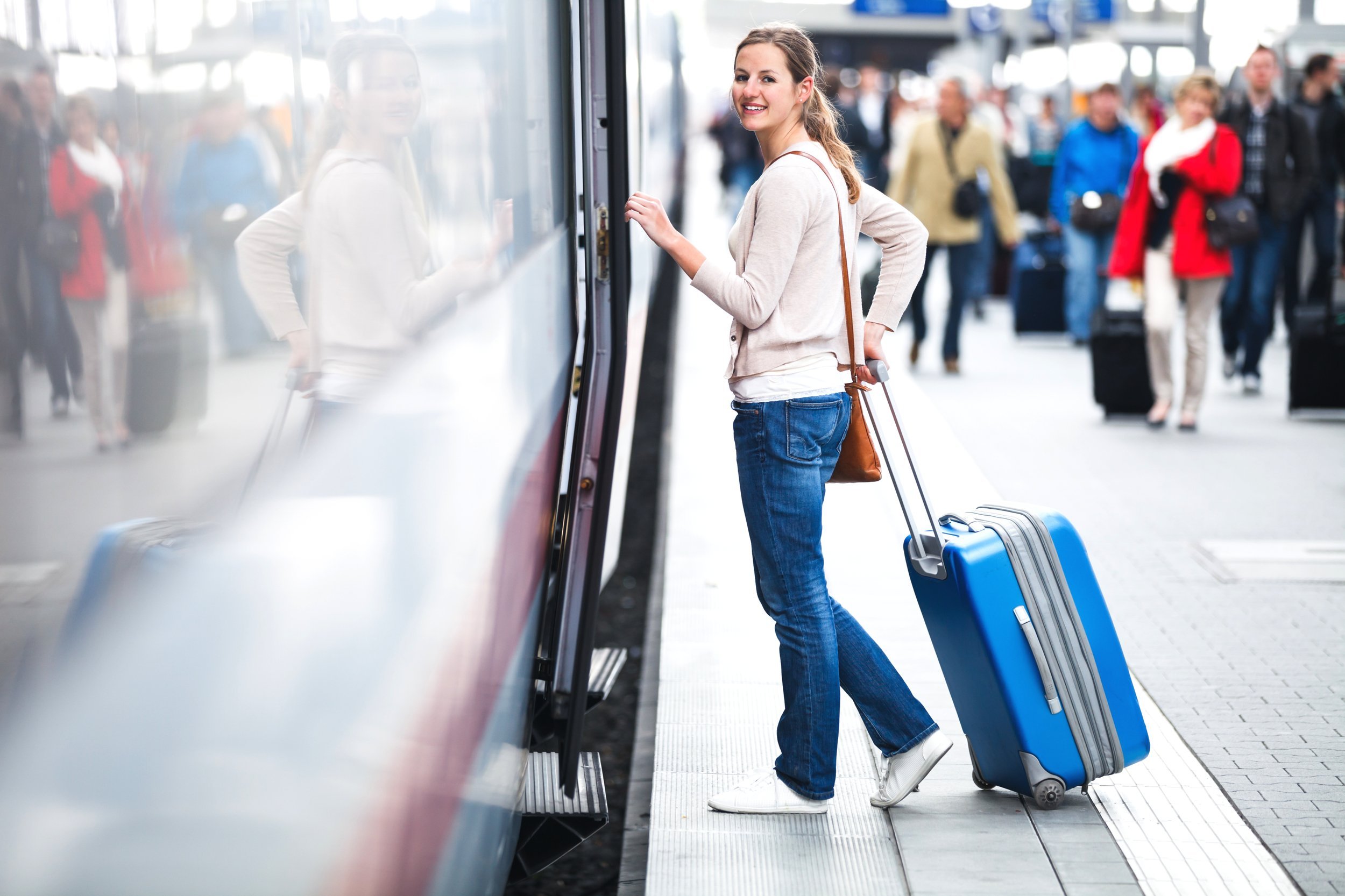 Pretty young woman boarding a train.