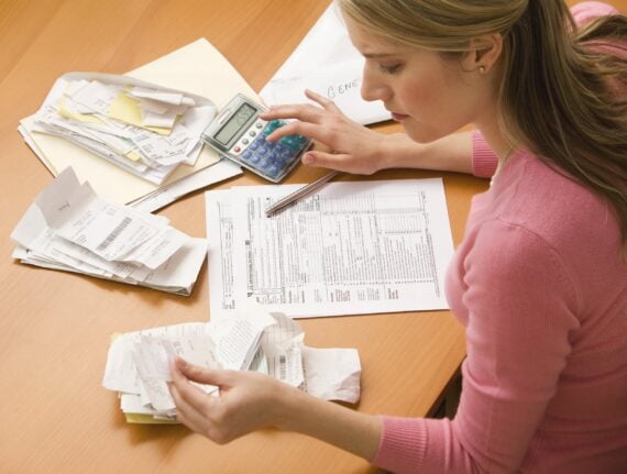 High angle view of a young woman using a laptop computer to organize her finances.