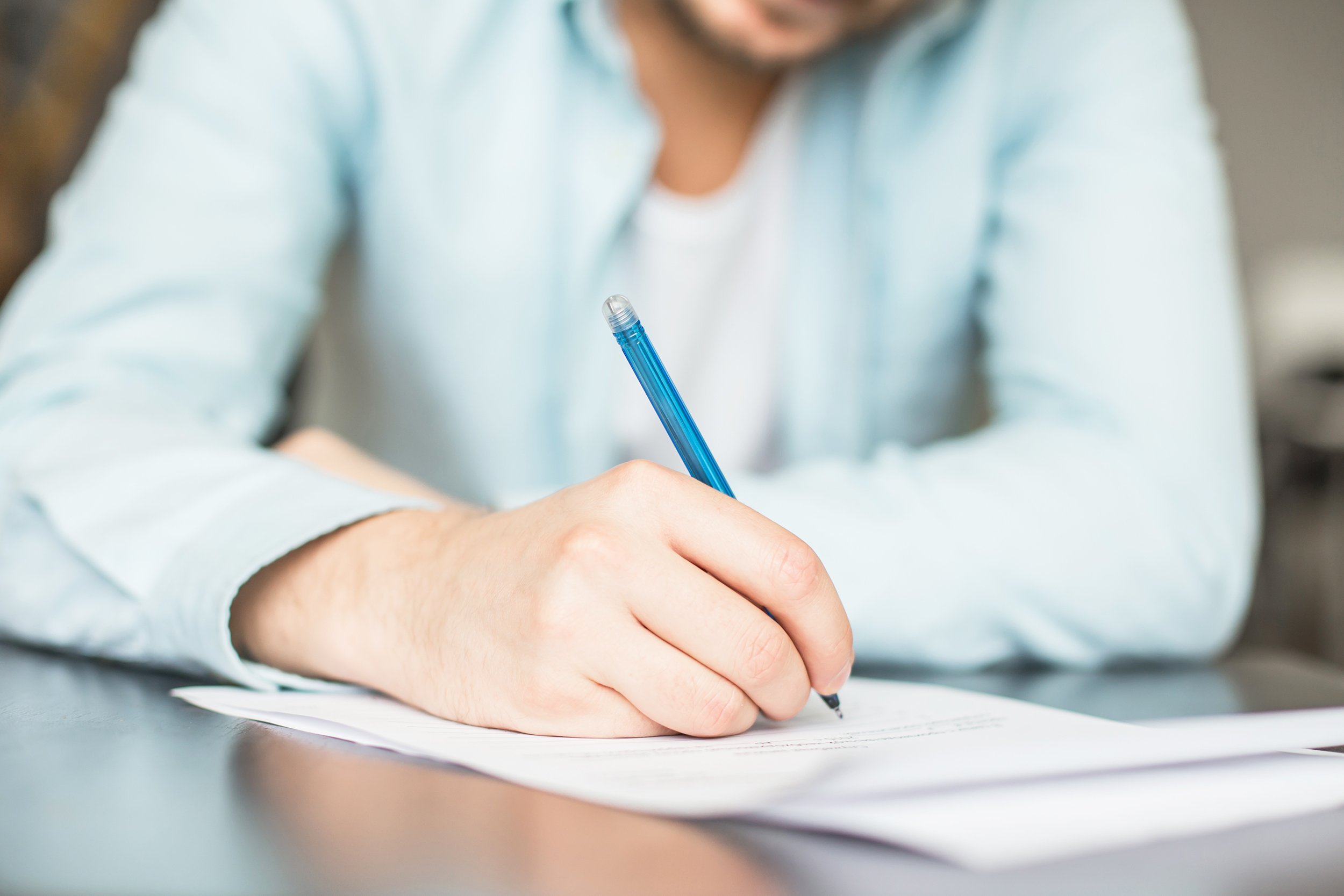 man writing at the desk