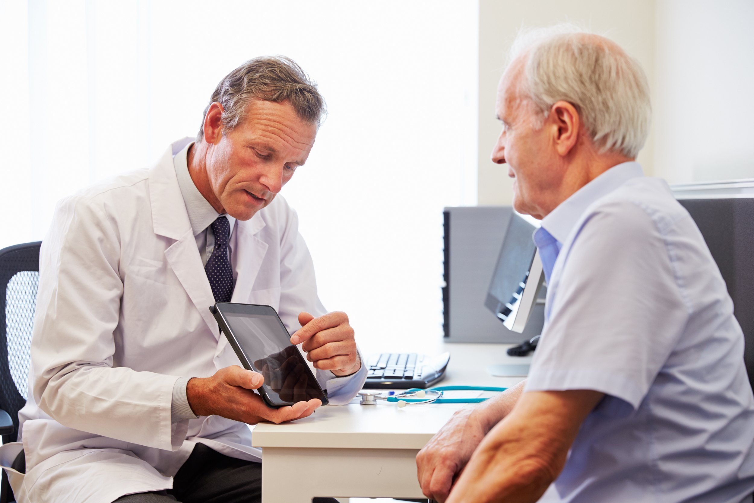 senior patient having consultation with doctor in office