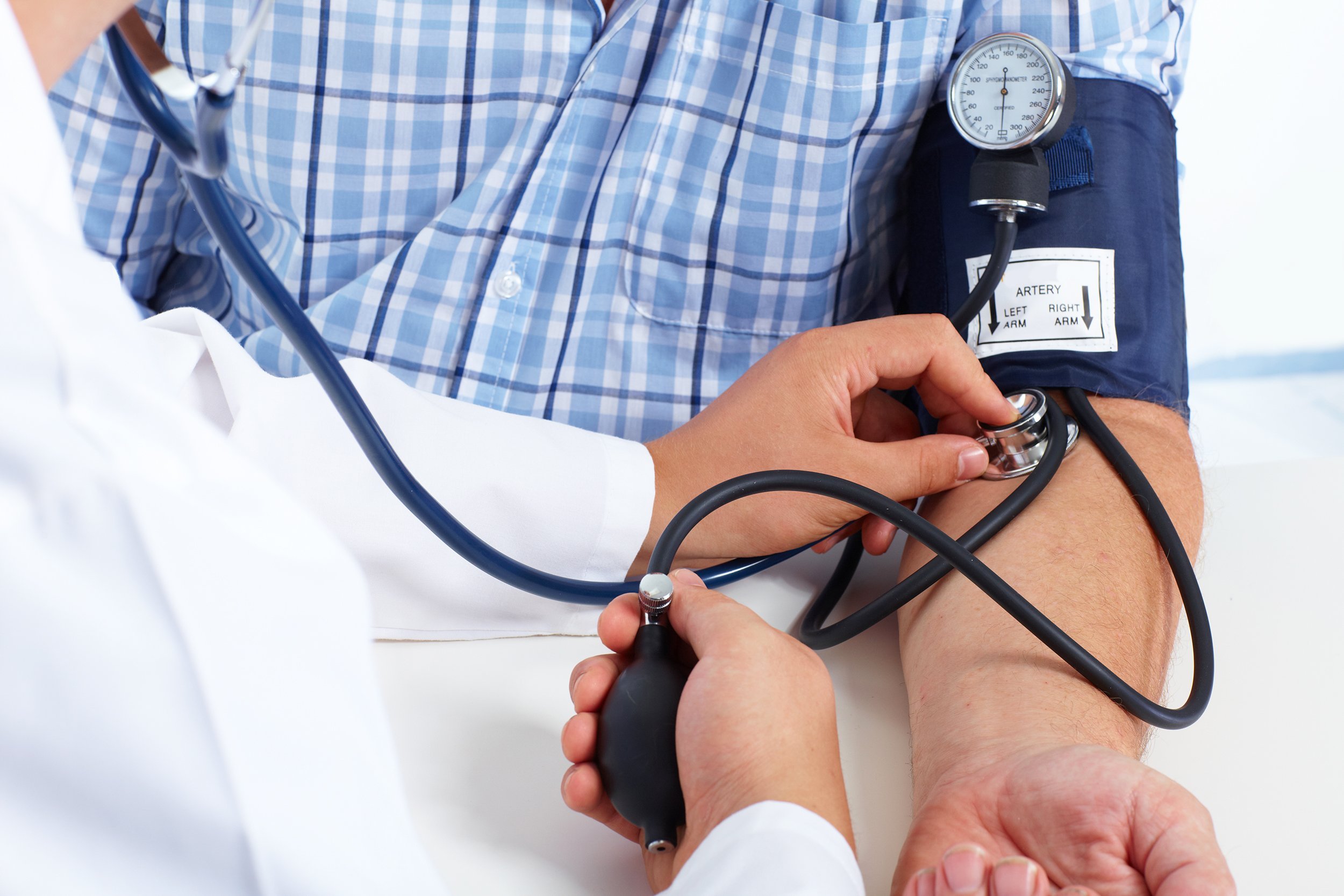 doctor checking old man patient arterial blood pressure