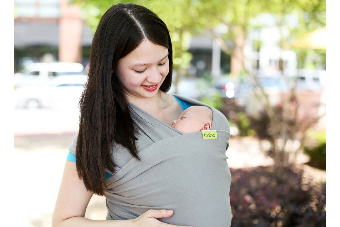 Baby in a sling with mother