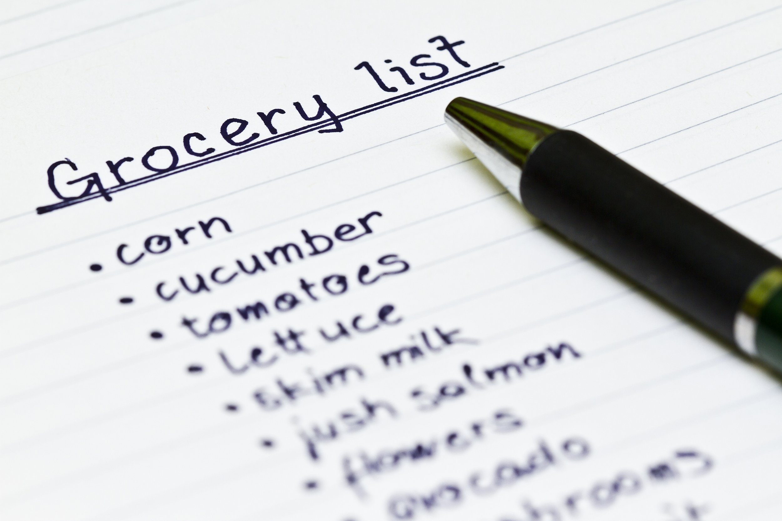 grocery list with metal ball point pen