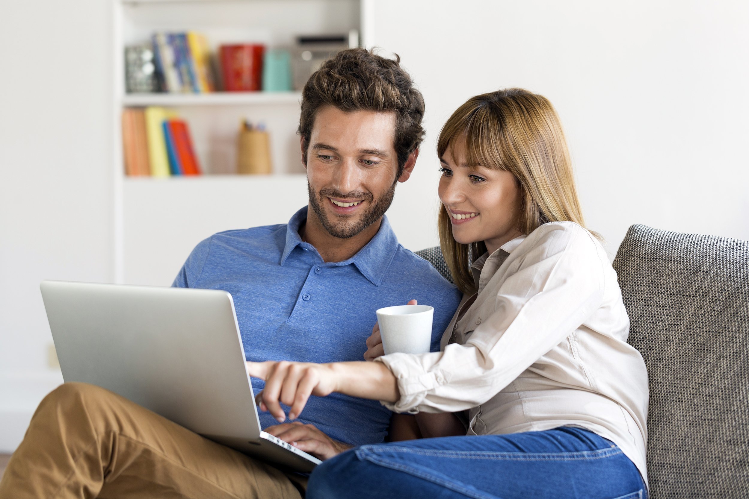 Couple surfing the web on a laptop at home