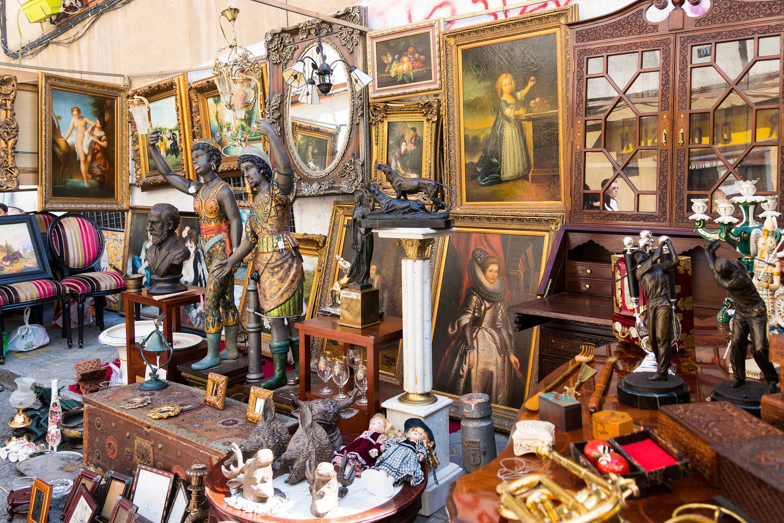 Crowded flea market with lots of artwork