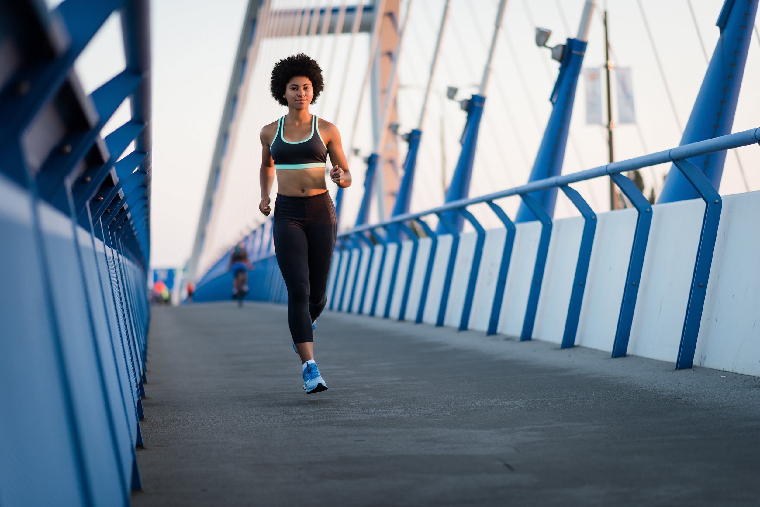 athletic woman runner in action during sunset
